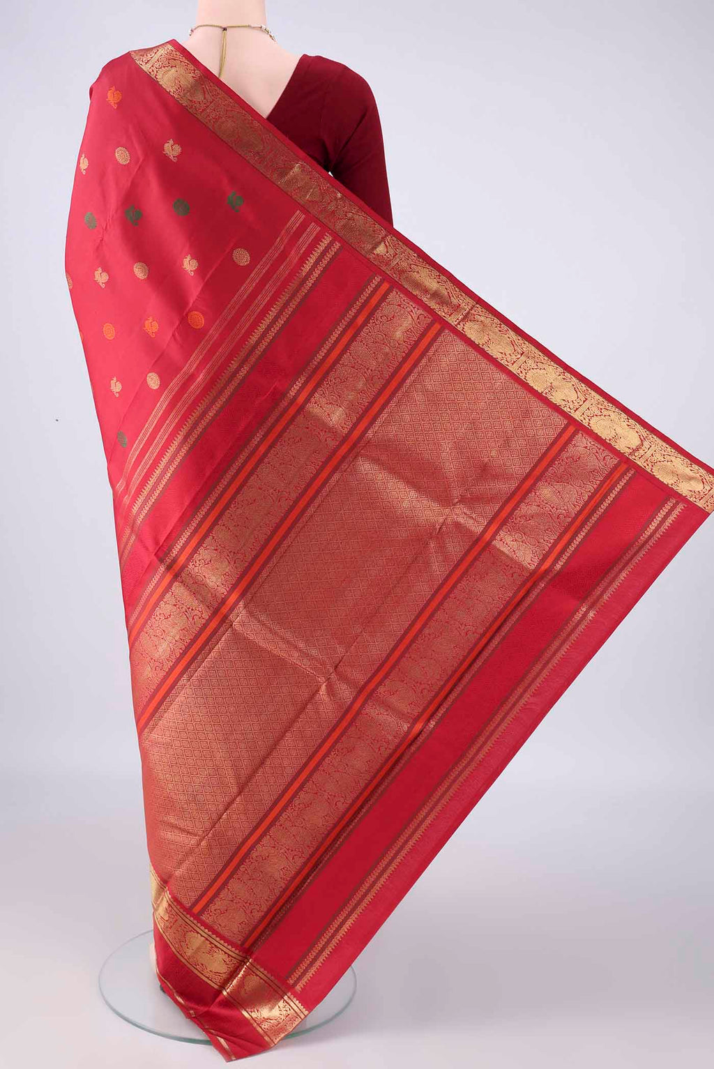 Flat view of Pure Silk Pure Zari Red Kanjivaram Saree with Zari And Thread Butta on the body and Zari Border. 