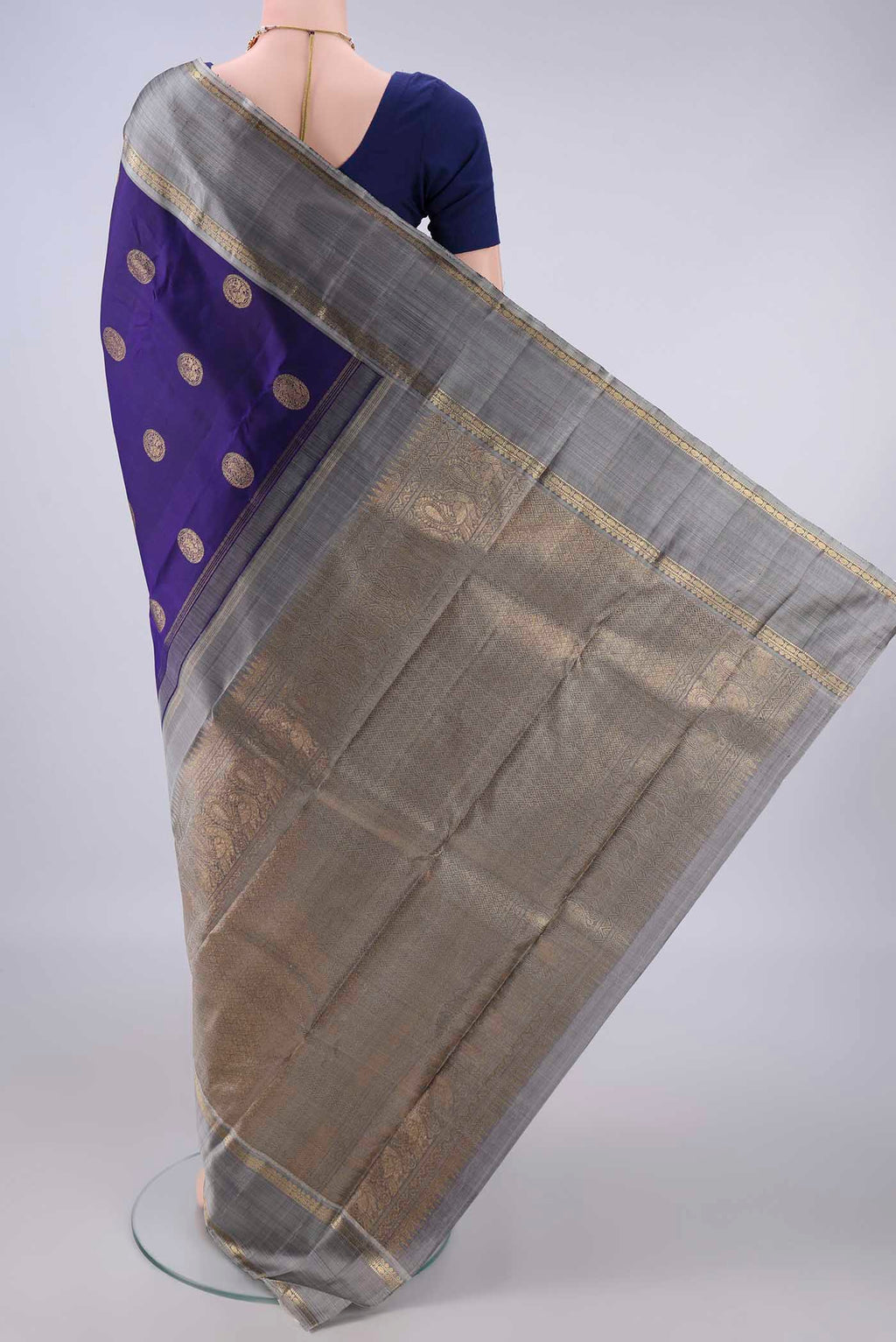 Flat view of Pure Silk Navy Blue Kanchipuram Saree with Zari Butta on the body and Zari Border. 
