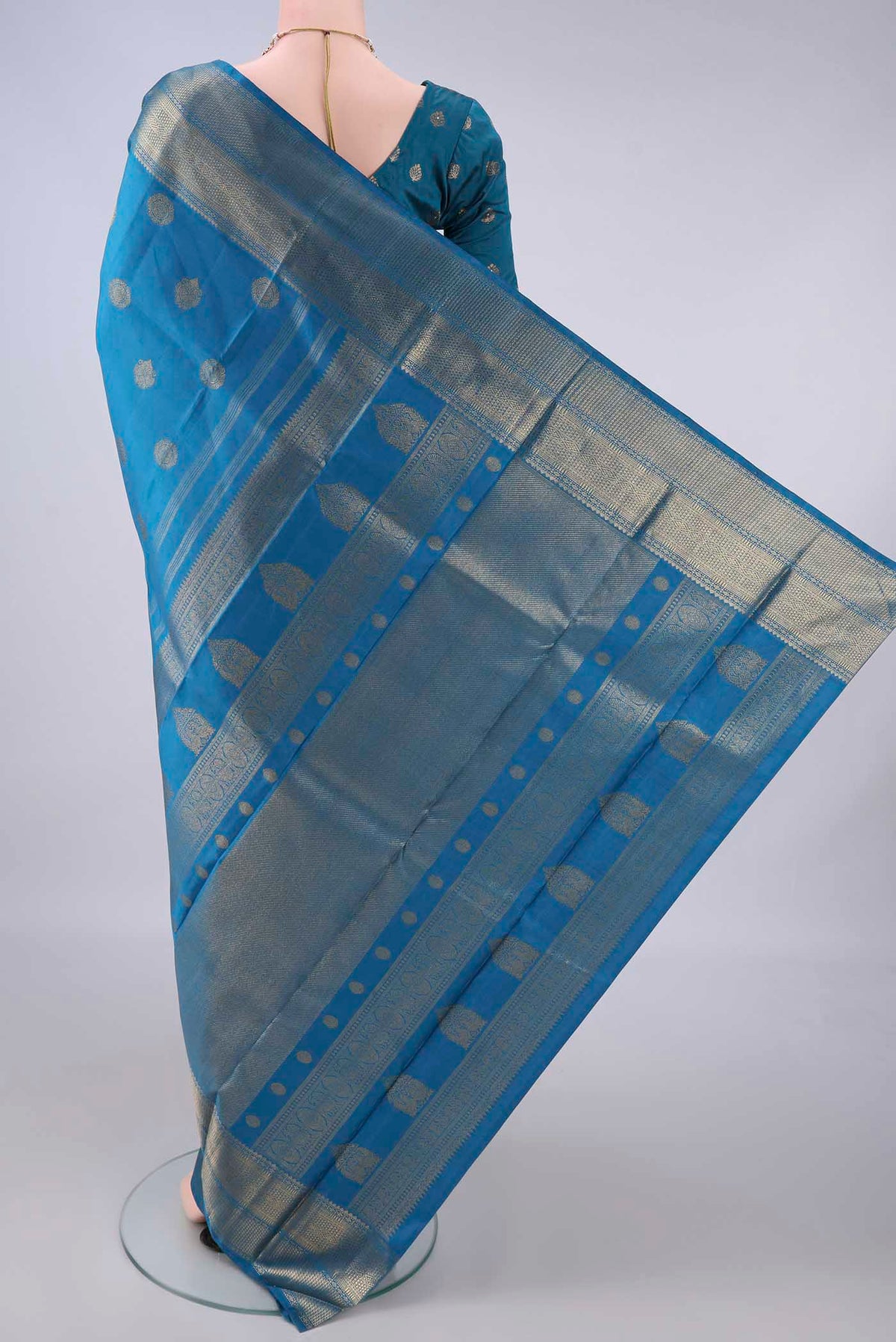 Flat view of Pure Silk Pure Zari Blue Kanjivaram Saree with Zari Butta on the body and Zari Border. 