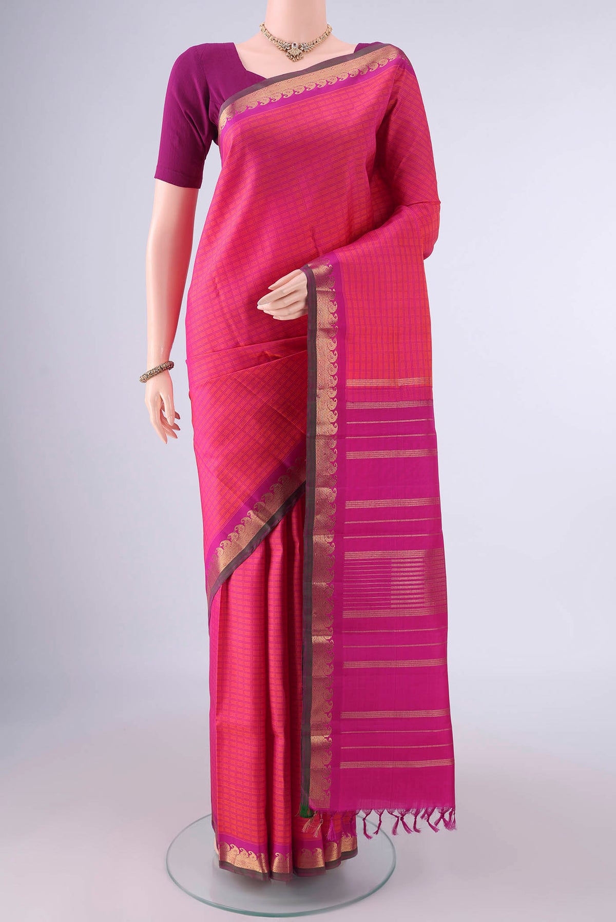 Pure Silk Coral Kanchipuram Saree with Checked design on the body and Zari Border.  displayed on a mannequin