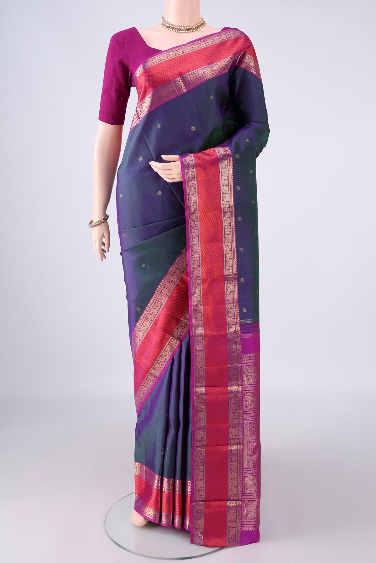 Pure Silk Pure Zari Peacock Blue Dual Tone Kanjivaram Saree with Zari Butta on the body and Zari And Thread Border.  displayed on a mannequin
