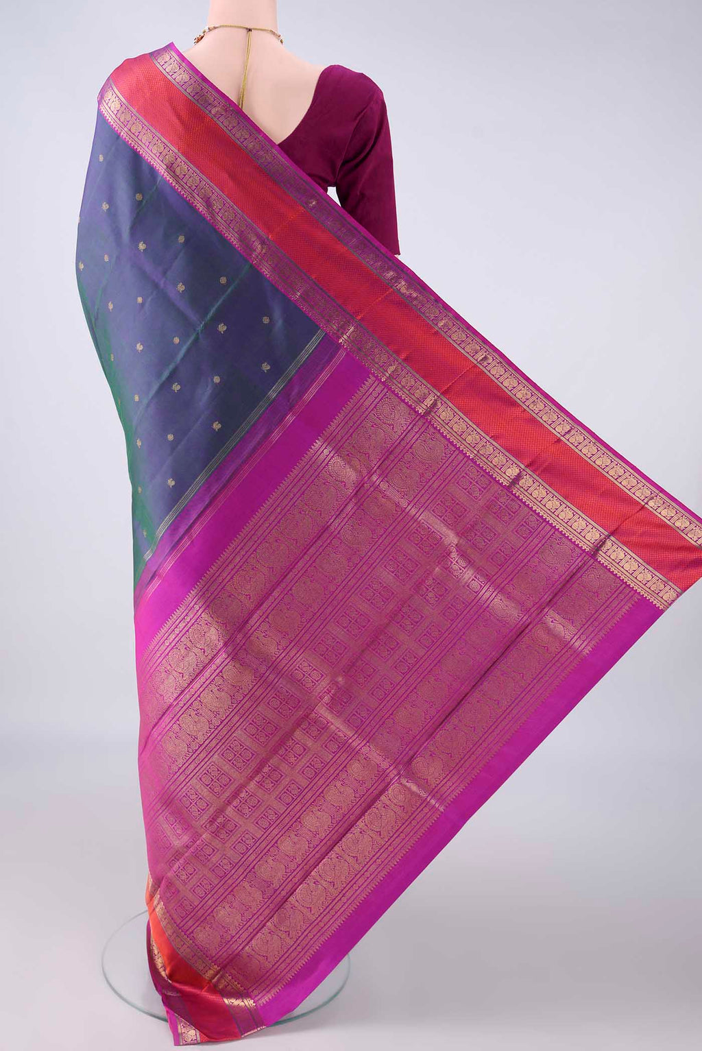 Flat view of Pure Silk Pure Zari Peacock Blue Dual Tone Kanjivaram Saree with Zari Butta on the body and Zari And Thread Border. 
