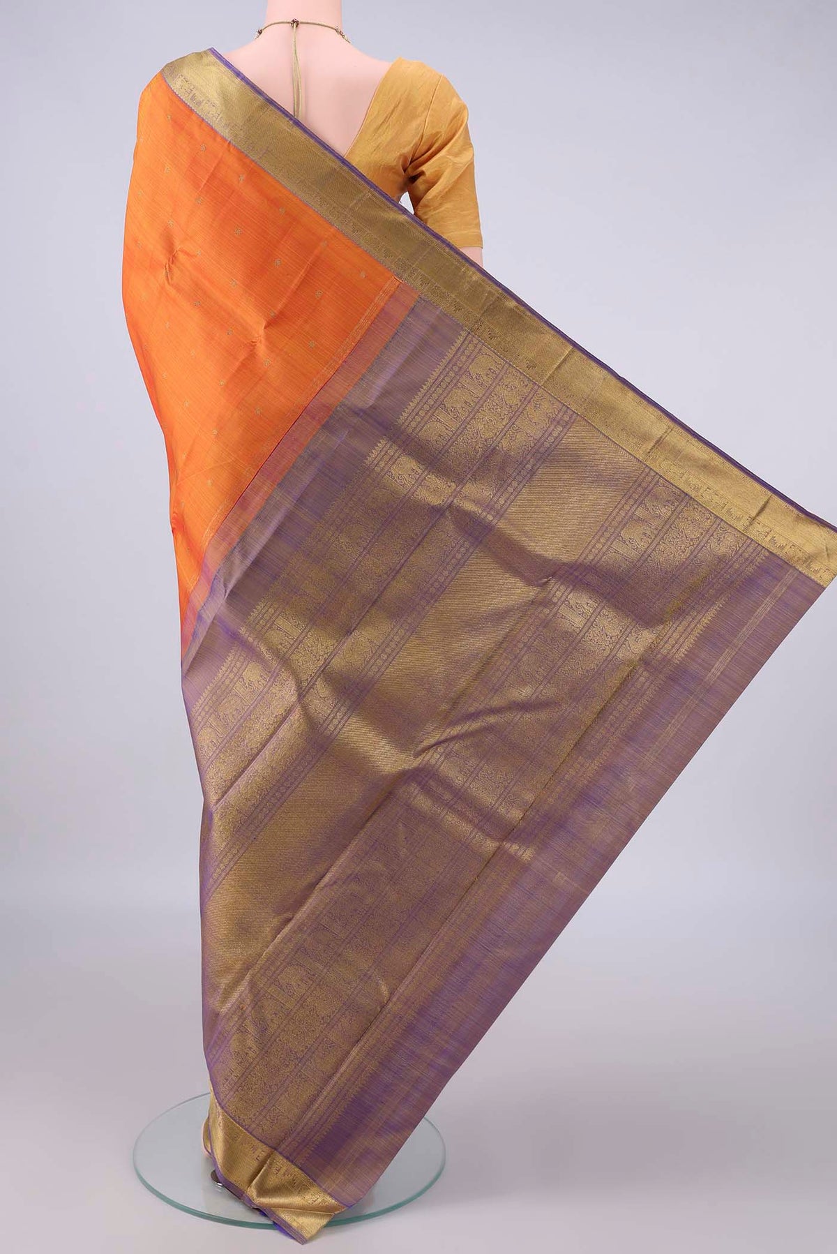 Flat view of Pure Silk Pure Zari Orange Kanjivaram Saree with Zari Butta on the body and Zari Border. 