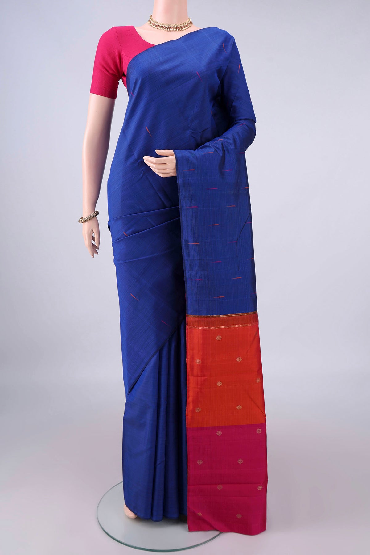Pure Silk Blue Kanjivaram Saree with Thread Butta on the body and Without Border.  displayed on a mannequin