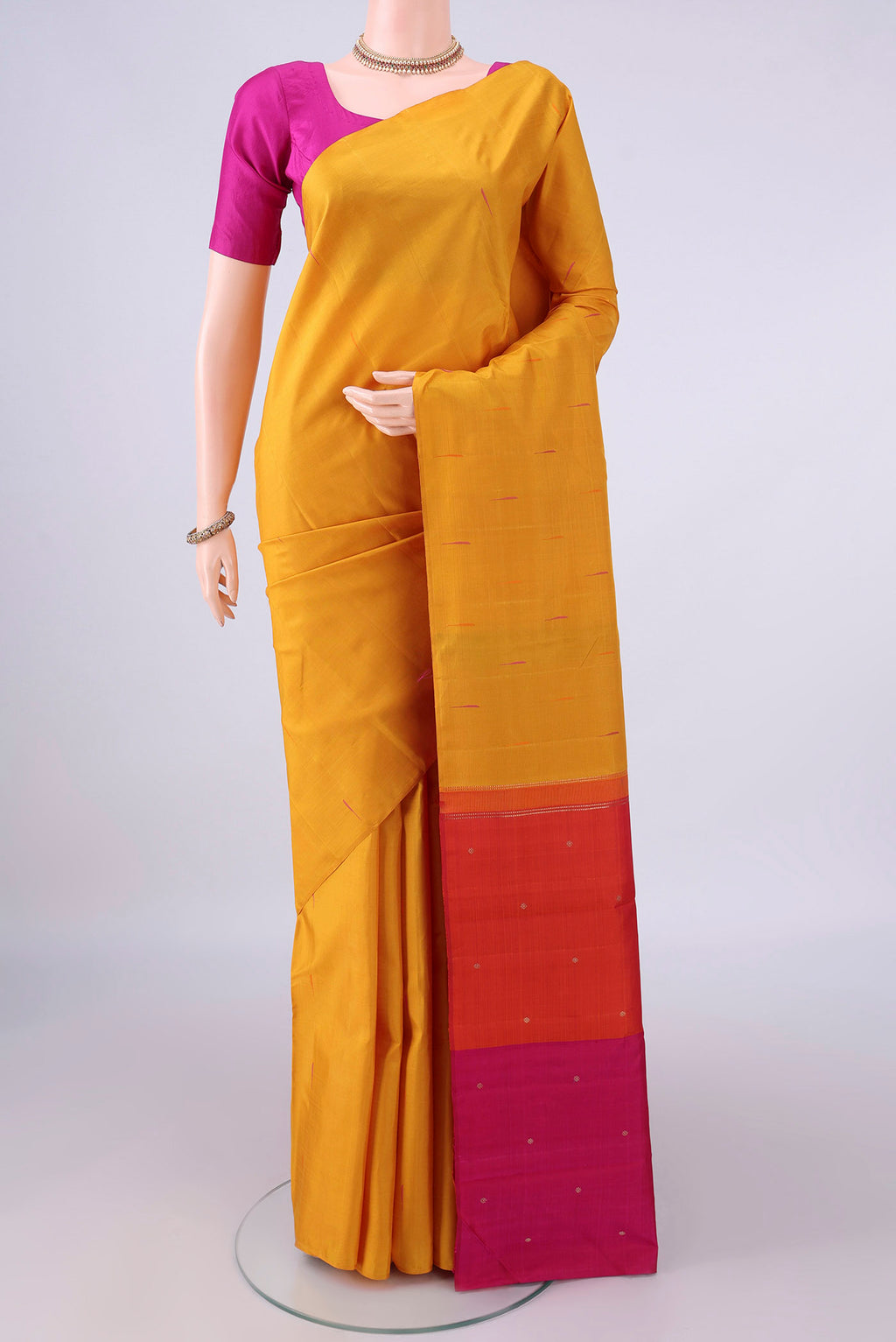 Pure Silk Yellow Kanjivaram Saree with Thread Butta on the body and Without Border.  displayed on a mannequin