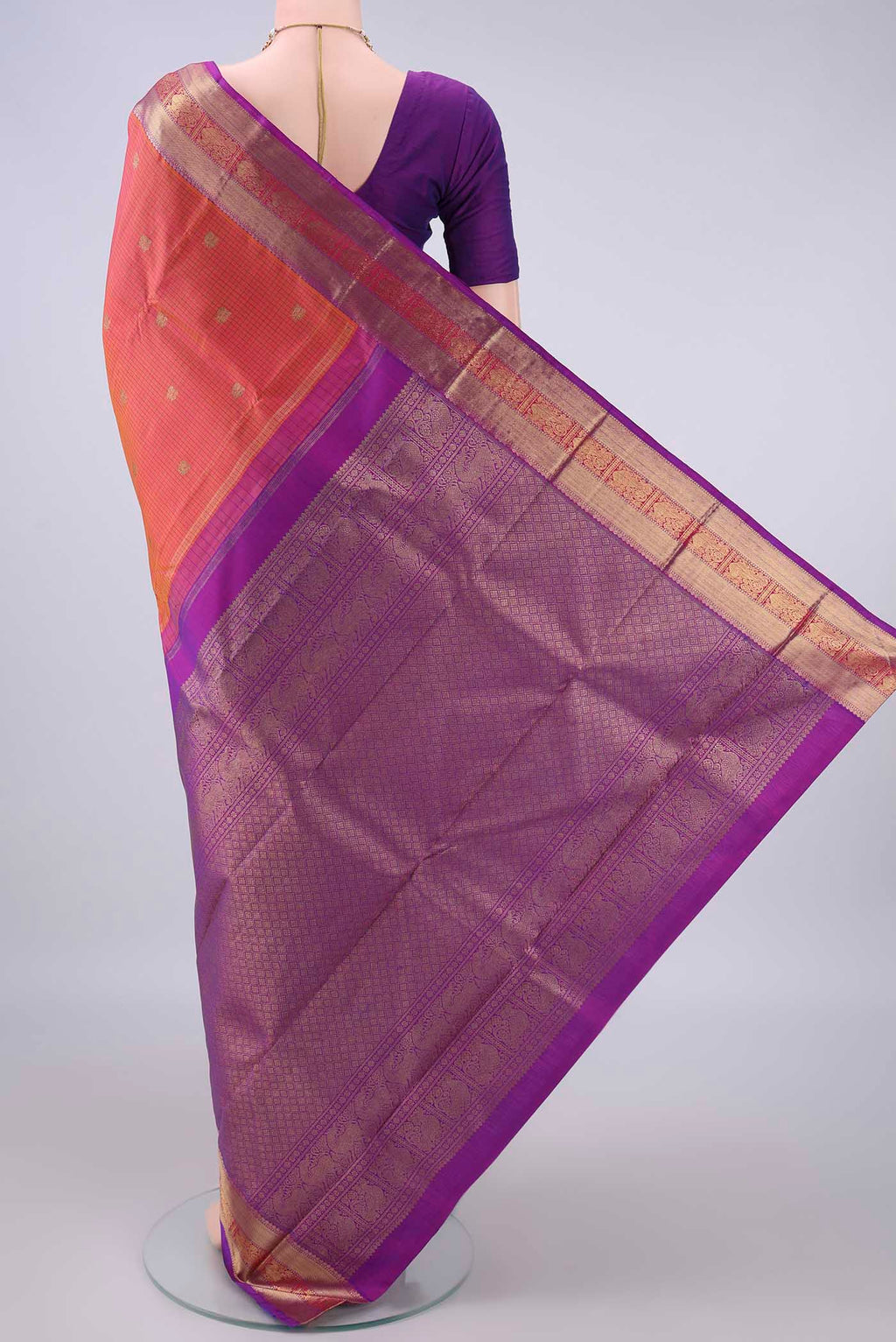 Flat view of Pure Silk Brick Orange Kanjivaram Saree with Checked design on the body and Zari Border. 
