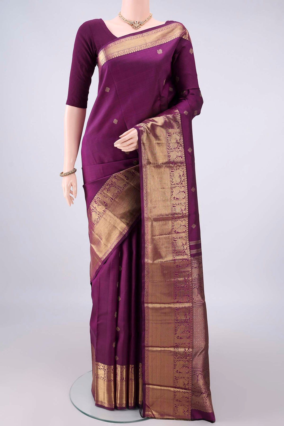 Pure Silk Pure Zari Purple Kanjivaram Saree with Zari Butta on the body and Zari Border.  displayed on a mannequin