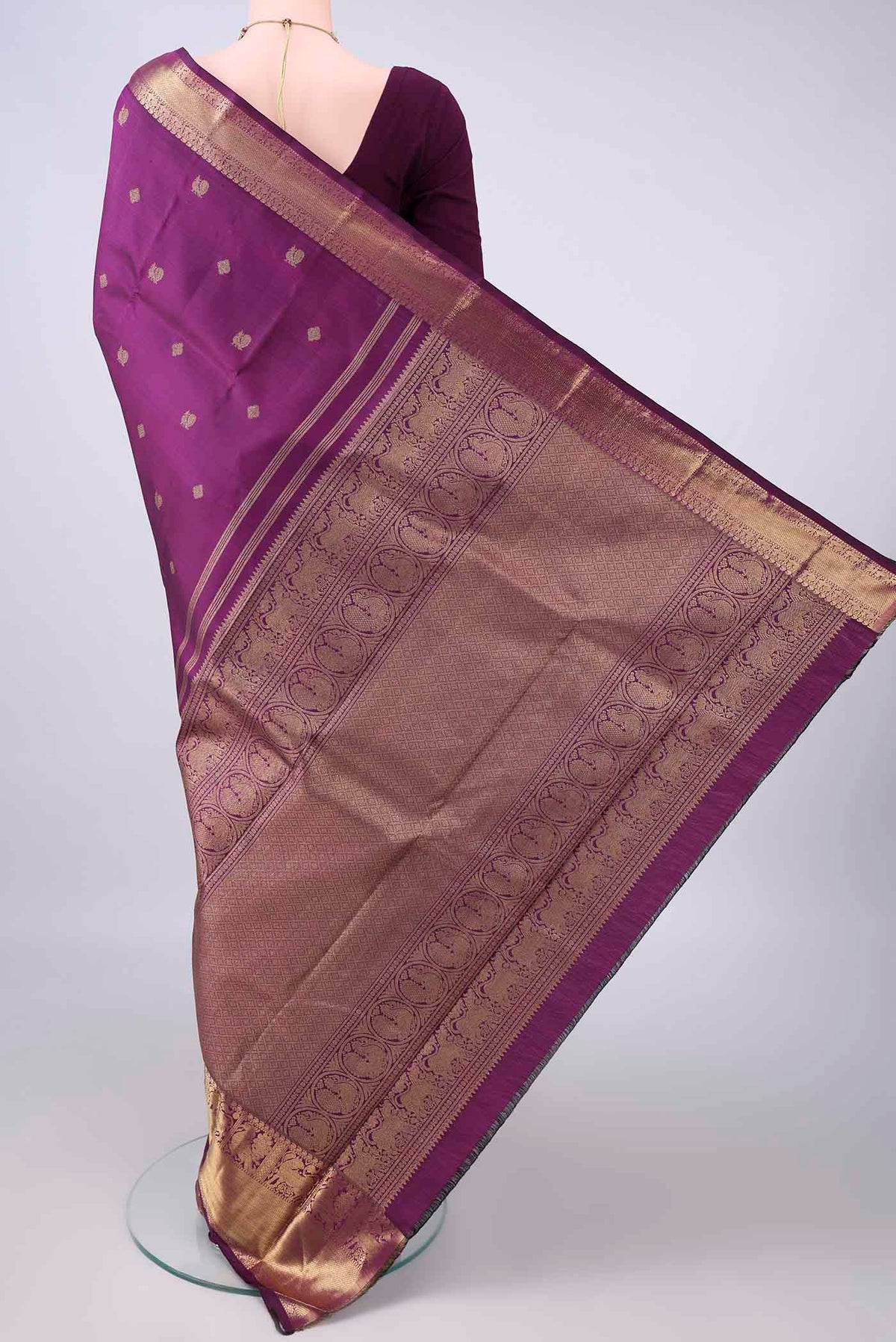 Flat view of Pure Silk Pure Zari Purple Kanjivaram Saree with Zari Butta on the body and Zari Border. 