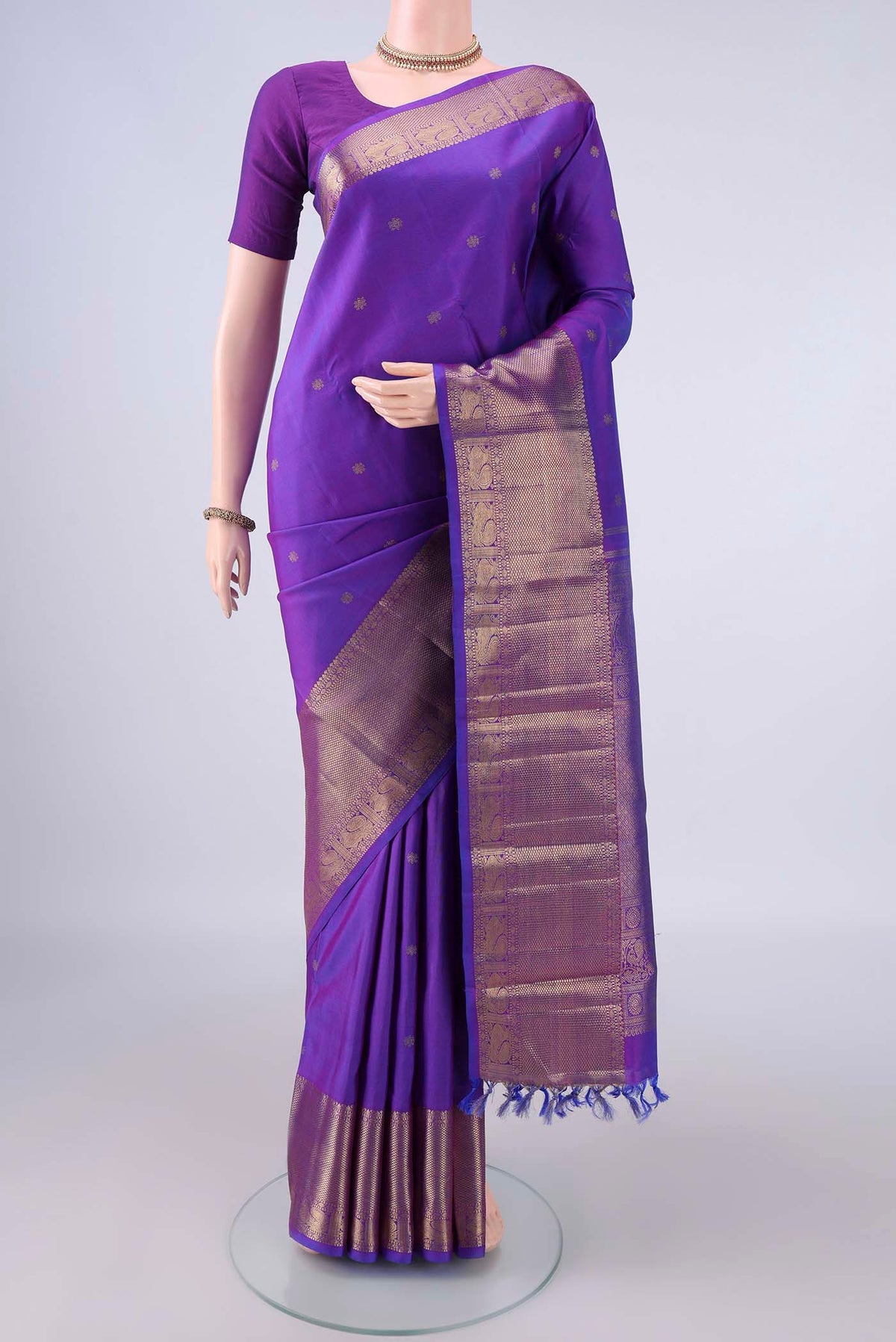 Pure Silk Pure Zari Violet Kanjivaram Saree with Zari Butta on the body and Zari Border.  displayed on a mannequin