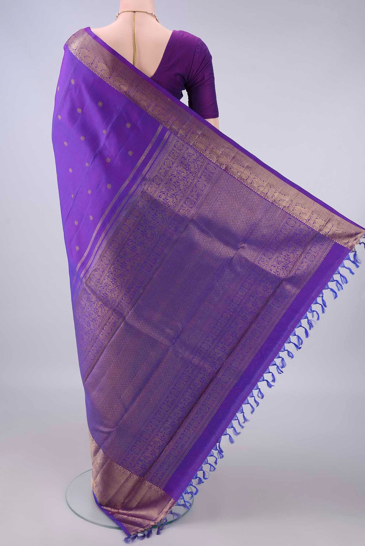Flat view of Pure Silk Pure Zari Violet Kanjivaram Saree with Zari Butta on the body and Zari Border. 