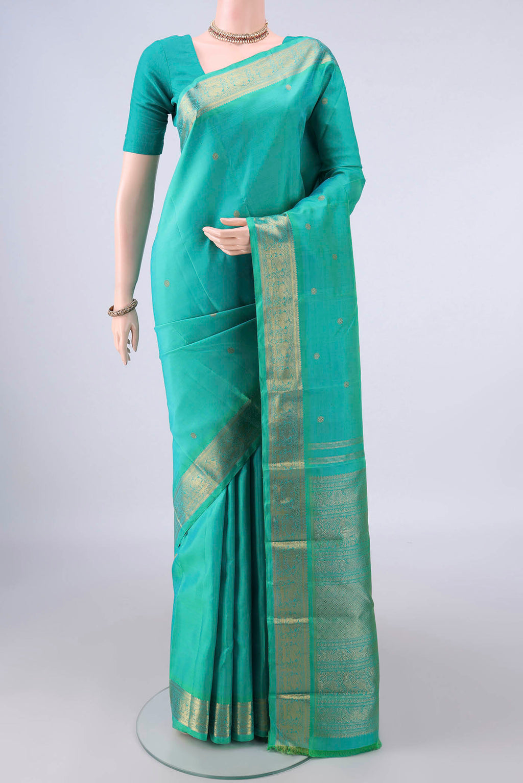 Pure Silk Pure Zari Sea Green Kanjivaram Saree with Zari Butta on the body and Zari Border.  displayed on a mannequin