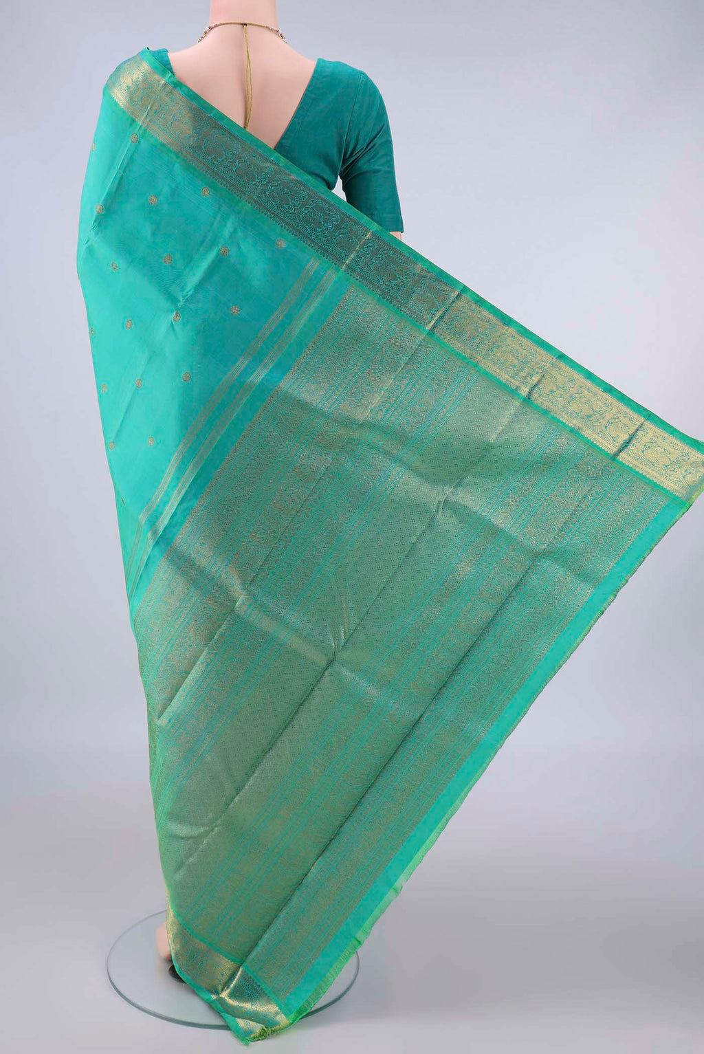 Flat view of Pure Silk Pure Zari Sea Green Kanjivaram Saree with Zari Butta on the body and Zari Border. 