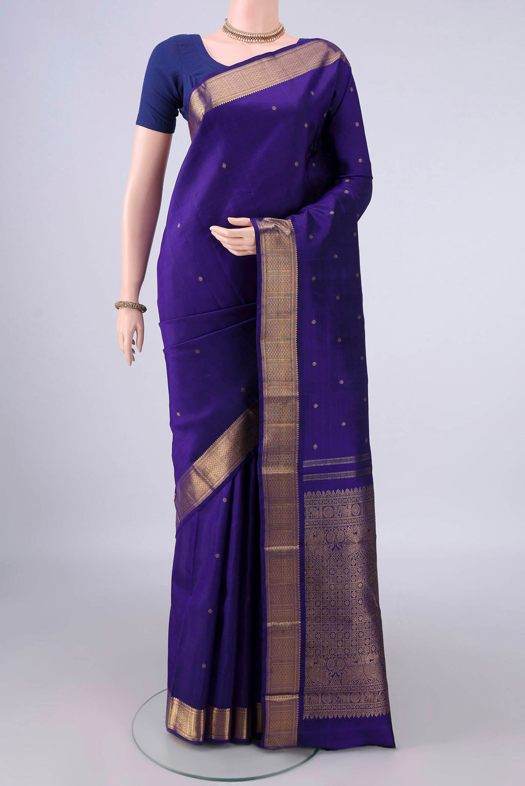 Pure Silk Pure Zari Violet Kanjivaram Saree with Zari Butta on the body and Zari Border.  displayed on a mannequin