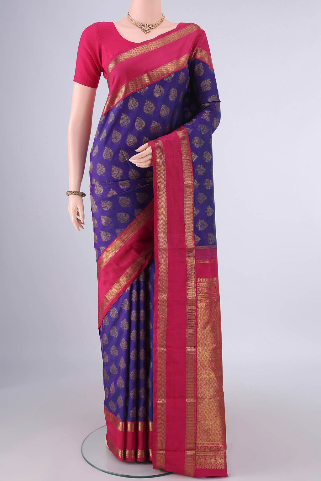 Pure Silk Blue Kanjivaram Saree with Zari Butta on the body and Zari Border.  displayed on a mannequin