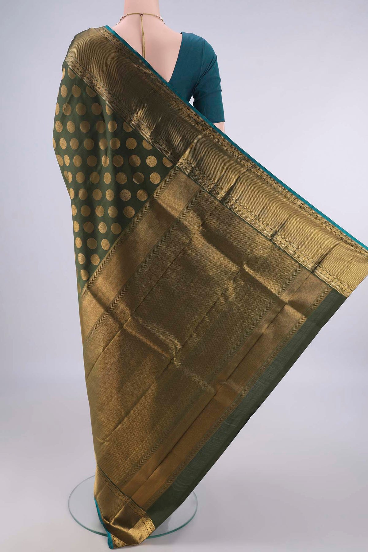 Flat view of Pure Silk Olive Green Kanchipuram Saree with Thread Butta on the body and Zari Border. 