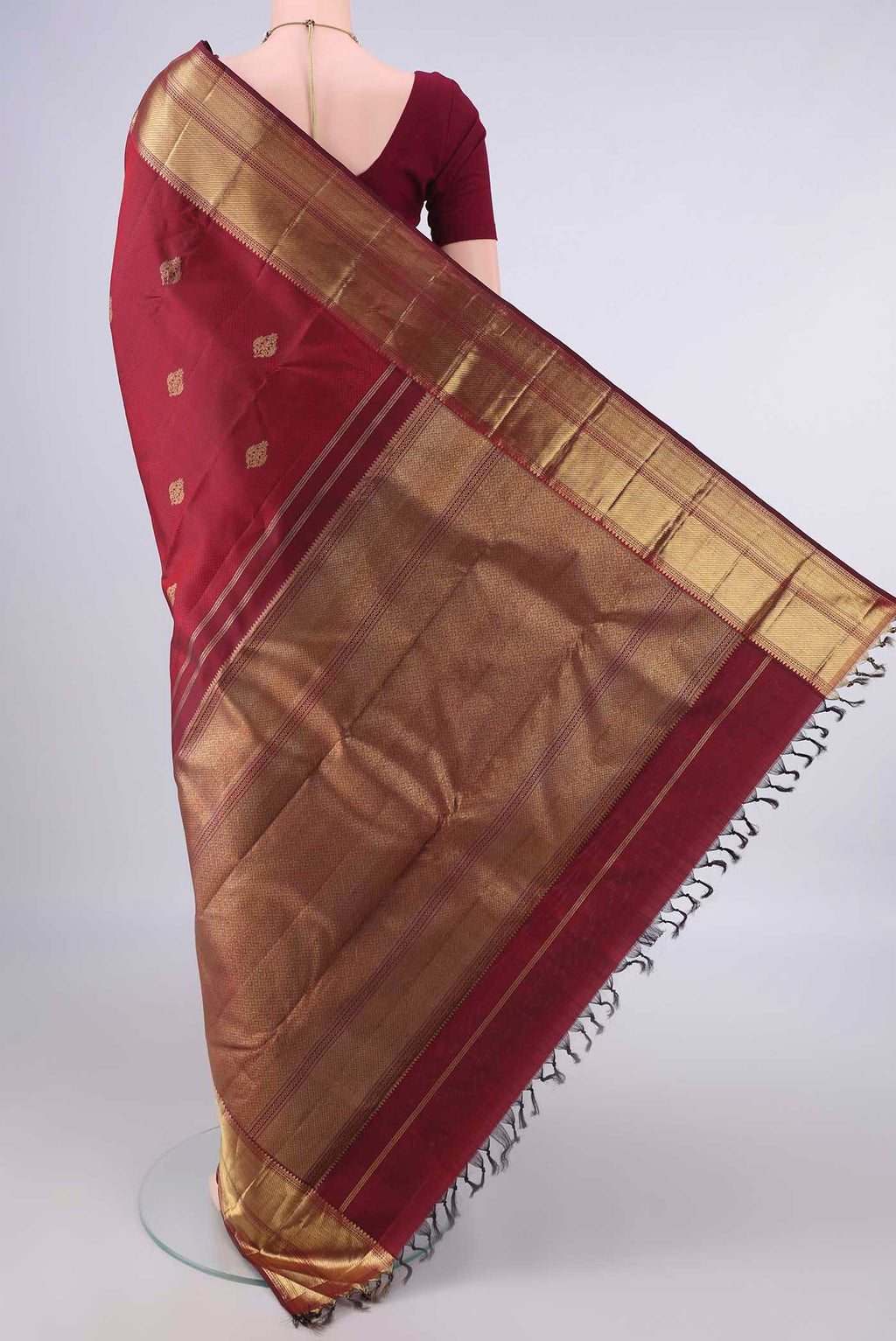 Flat view of Pure Silk Pure Zari Maroon Kanjivaram Saree with Jacquard With Zari Butta on the body and Zari Border. 