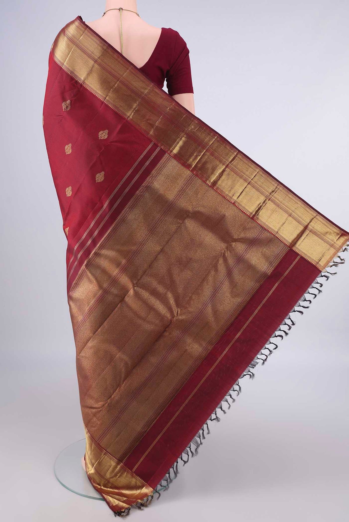 Flat view of Pure Silk Pure Zari Maroon Kanjivaram Saree with Jacquard With Zari Butta on the body and Zari Border. 