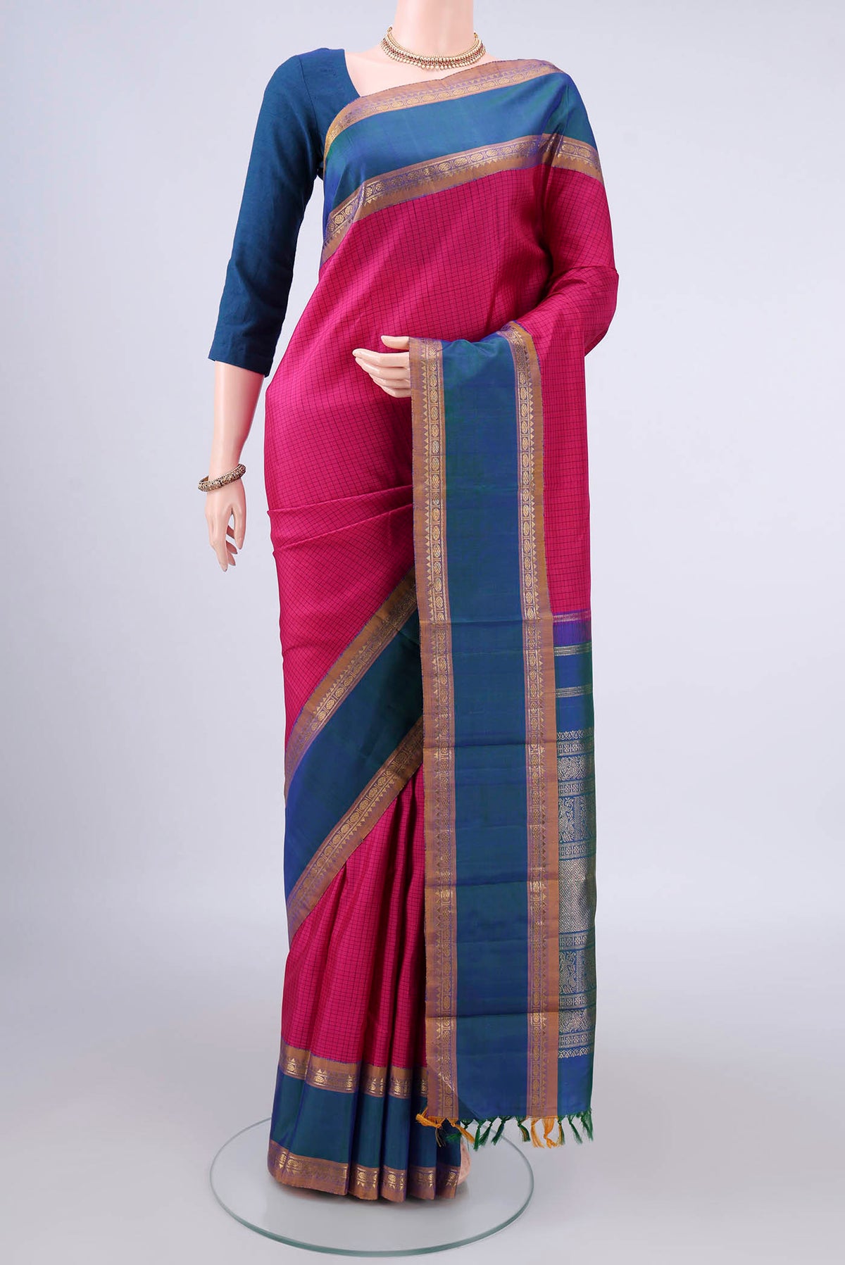 Pure Silk Rani Pink Kanjivaram Saree with Checked design on the body and Zari Border.  displayed on a mannequin