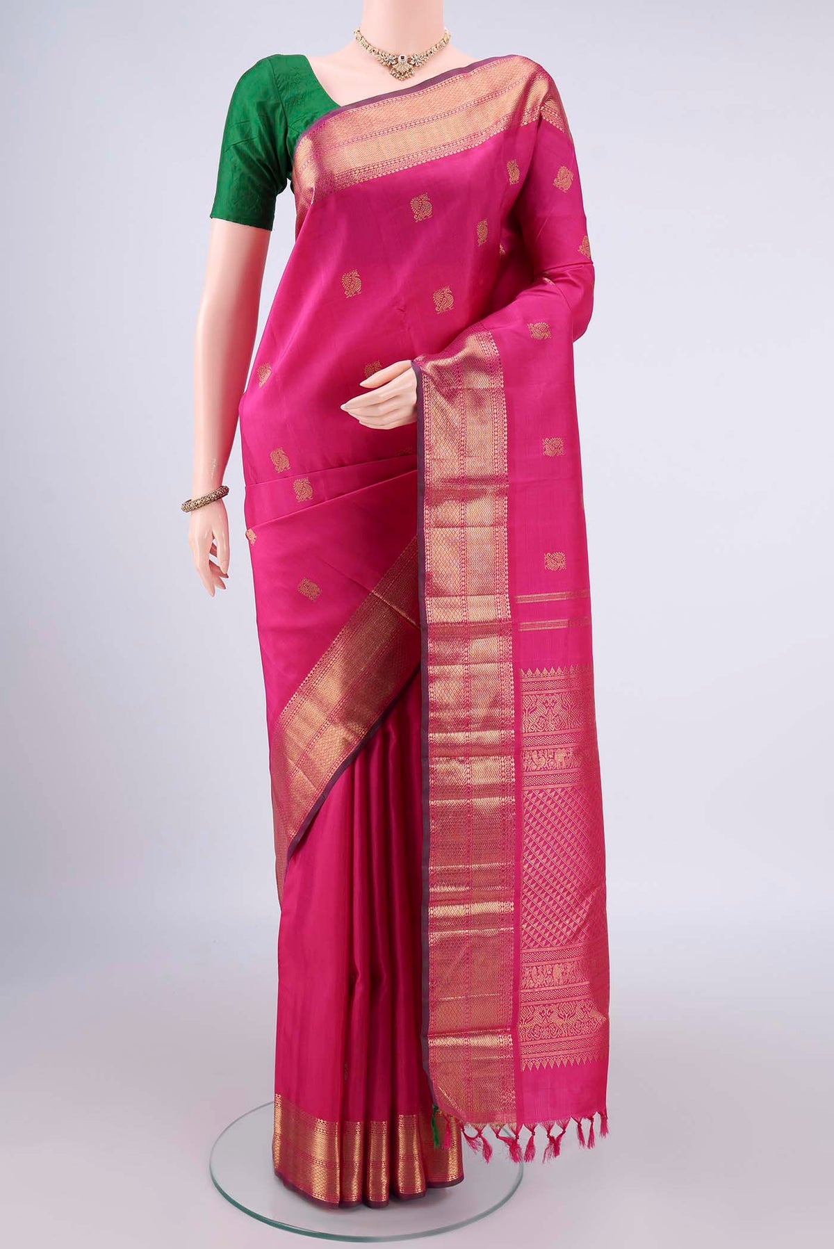 Pure Silk Pure Zari Pink Kanjivaram Saree with Zari Butta on the body and Zari Border.  displayed on a mannequin