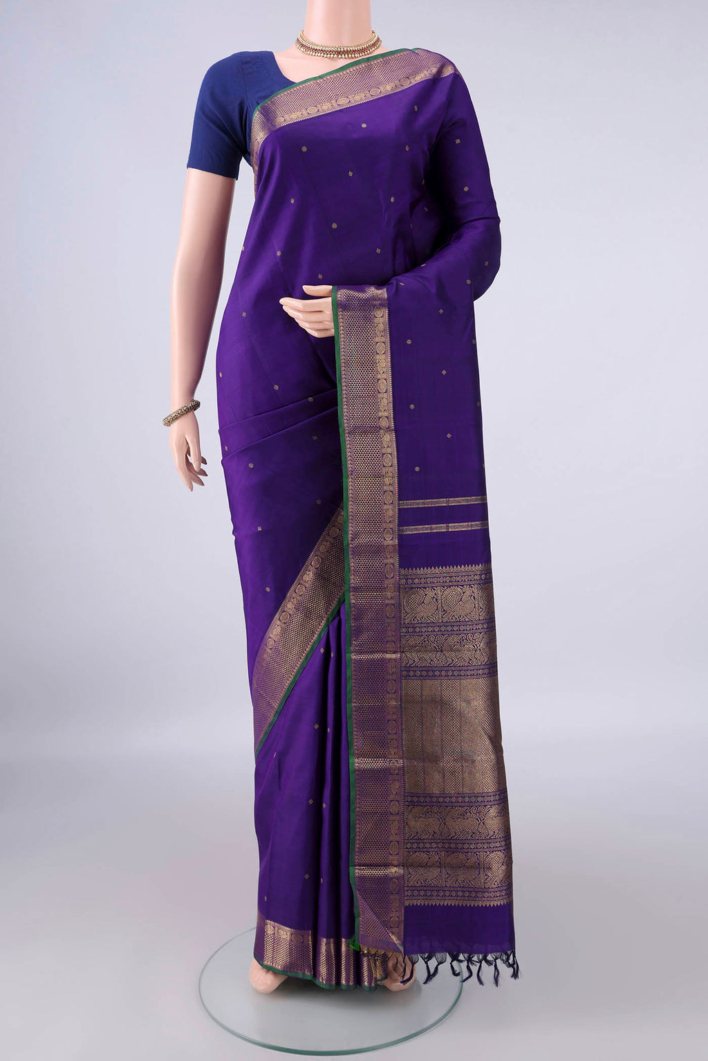 Pure Silk Pure Zari Violet Kanjivaram Saree with Zari Butta on the body and Zari Border.  displayed on a mannequin