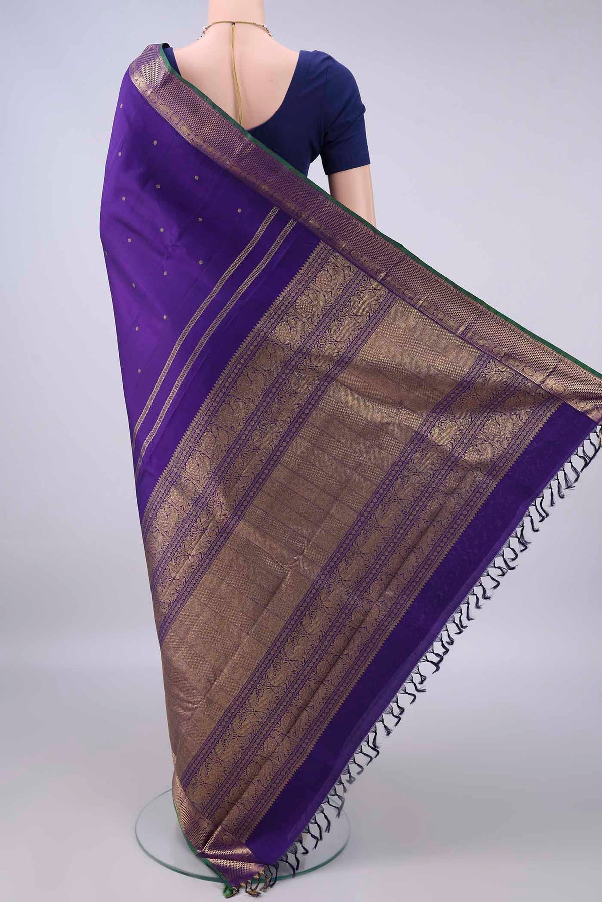 Flat view of Pure Silk Pure Zari Violet Kanjivaram Saree with Zari Butta on the body and Zari Border. 