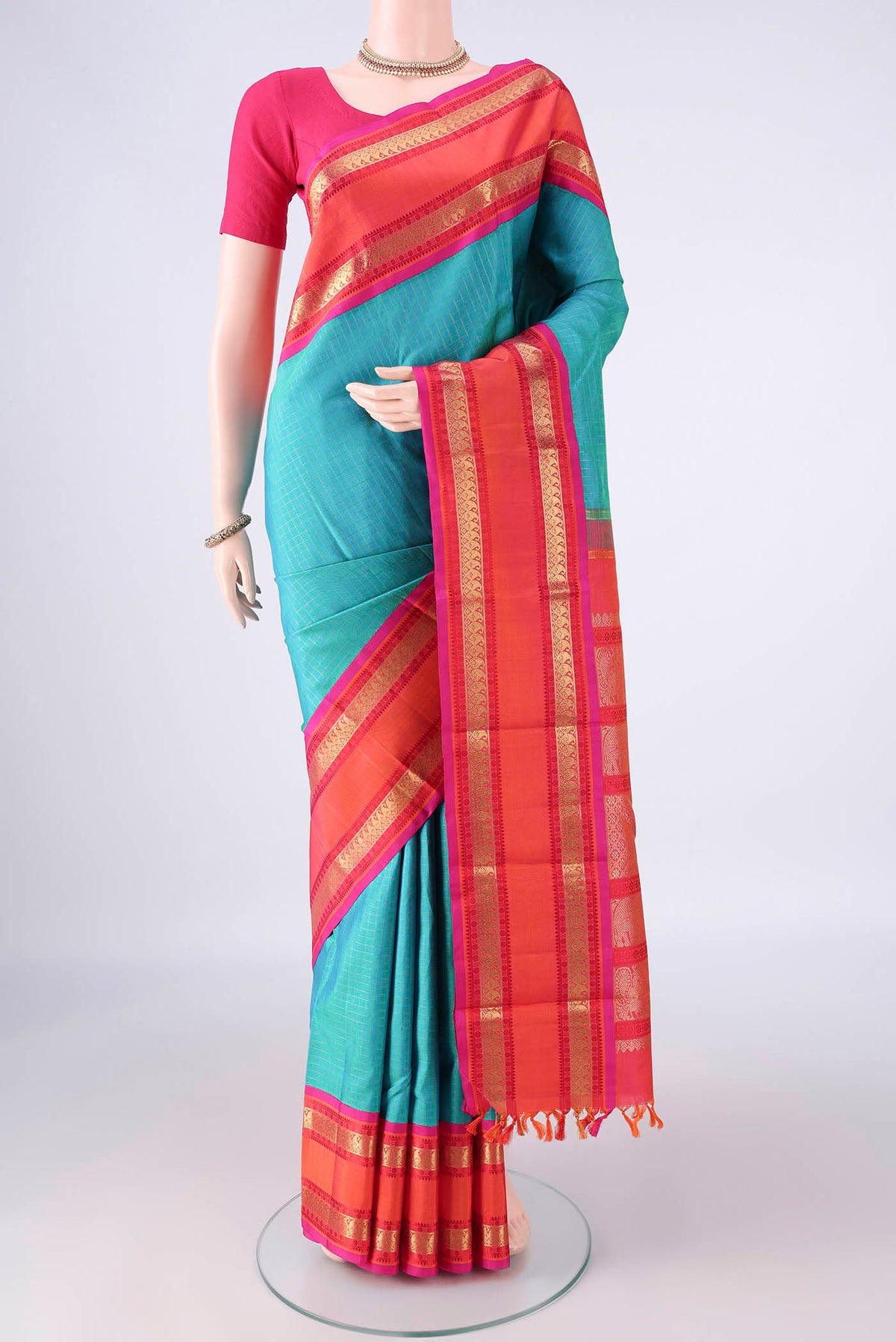 Pure Silk Pure Zari Turquoise Kanjivaram Saree with Checked design on the body and Thin Zari Line.  displayed on a mannequin
