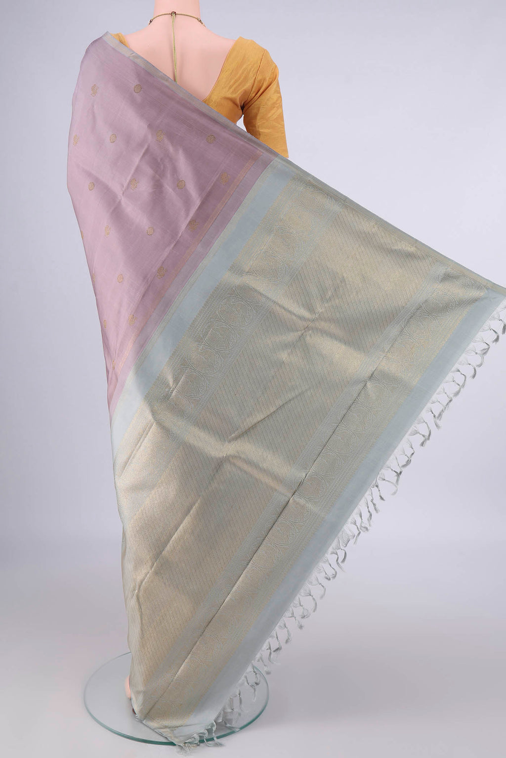 Flat view of Pure Silk Rose Gold Kanchipuram Saree with Zari Butta on the body and Thin Zari Line. 
