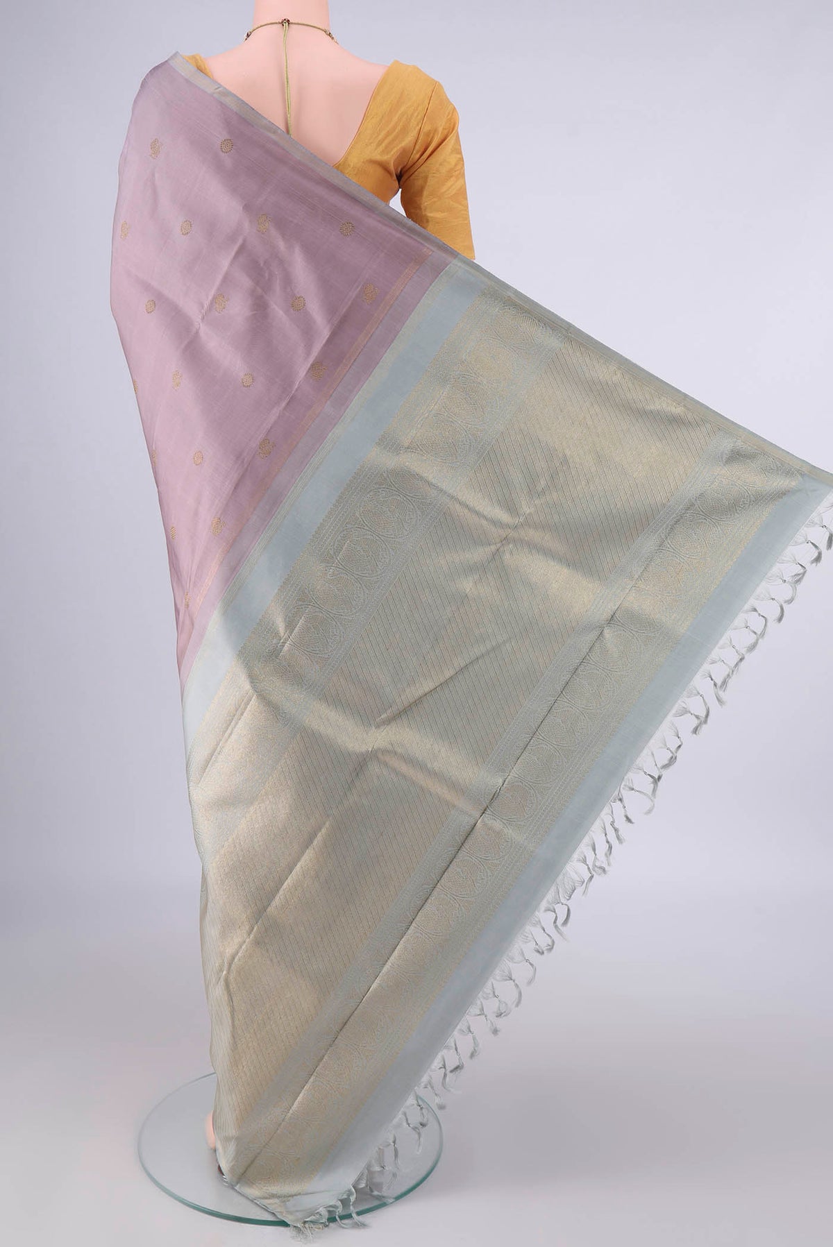 Flat view of Pure Silk Rose Gold Kanchipuram Saree with Zari Butta on the body and Thin Zari Line. 