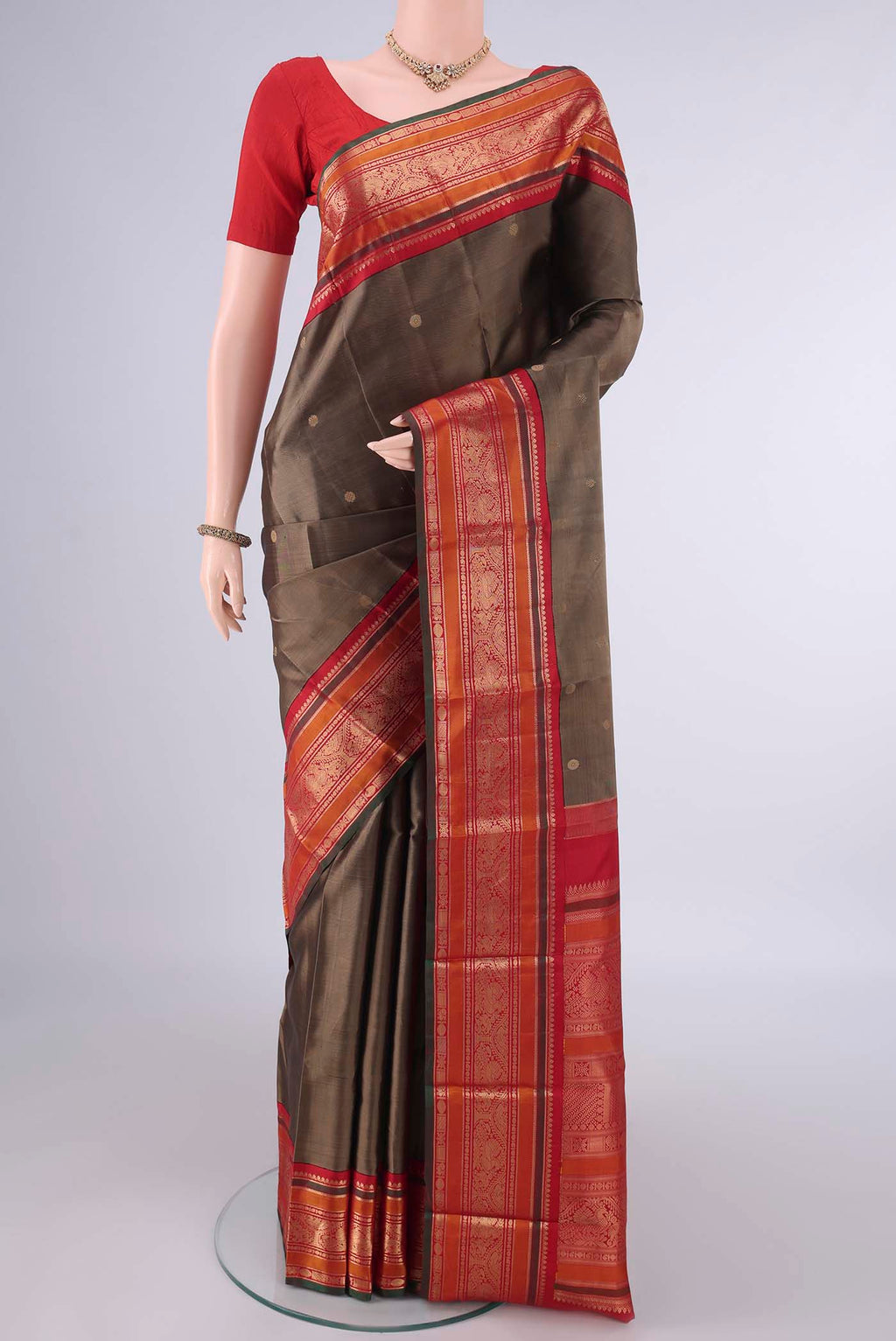 Pure Silk Brown Dual Tone Kanjivaram Saree with Zari Butta on the body and Zari Border.  displayed on a mannequin