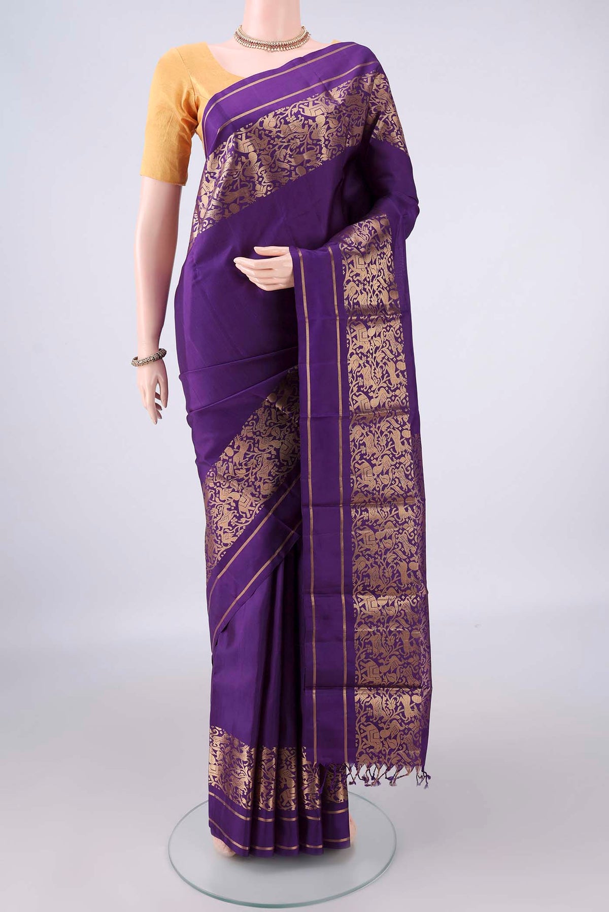 Pure Silk Purple Kanchipuram Saree with Plain Body and Zari Border.  displayed on a mannequin