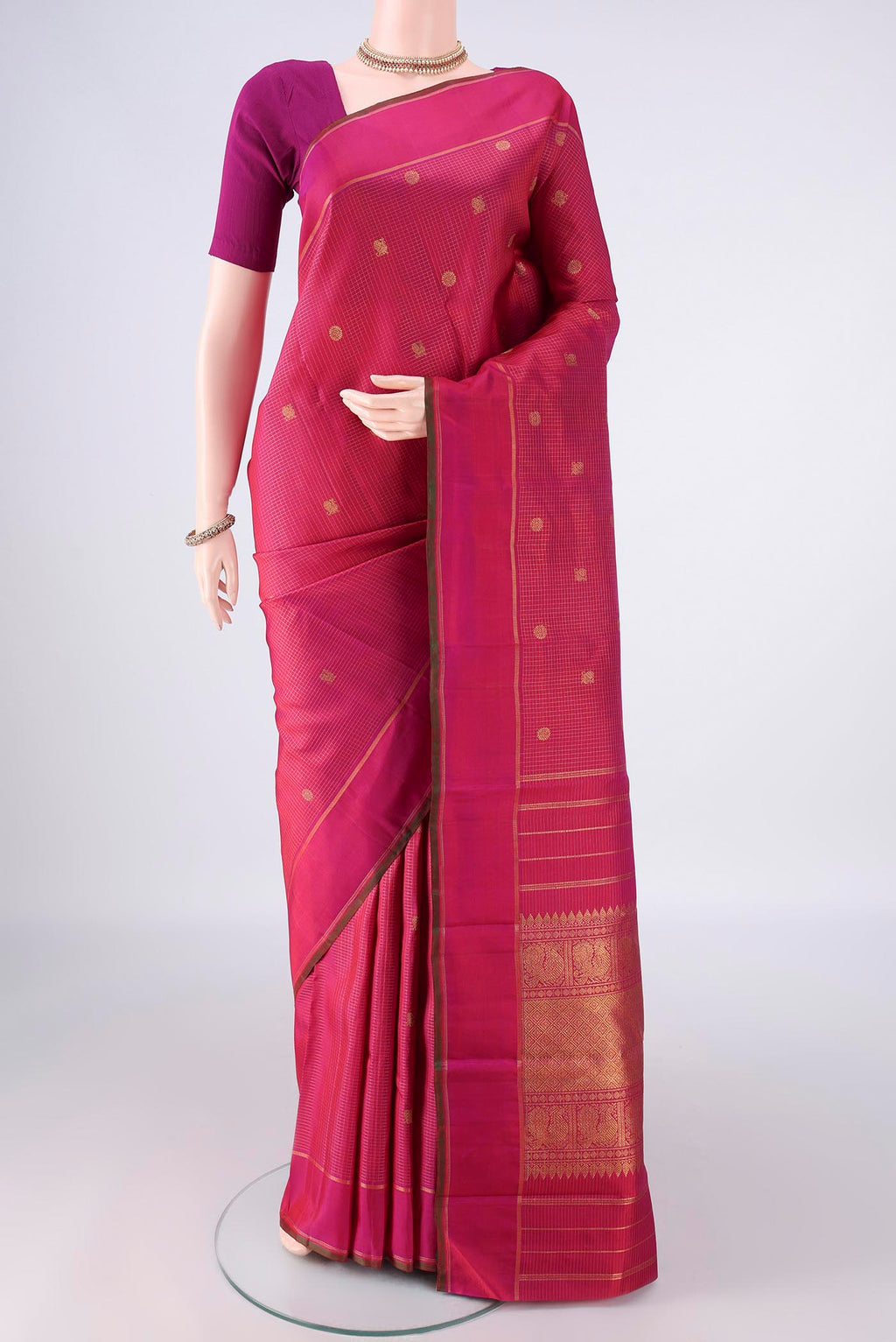 Pure Silk Pure Zari Pink Kanjivaram Saree with Checked design on the body and Zari Border.  displayed on a mannequin