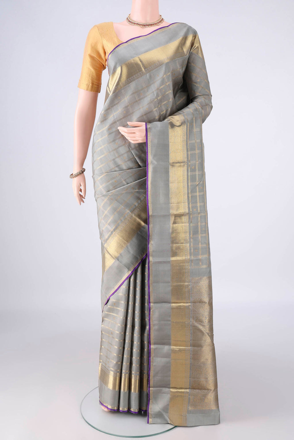 Pure Silk Pure Zari Grey Kanjivaram Saree with Checked design on the body and Zari Border.  displayed on a mannequin