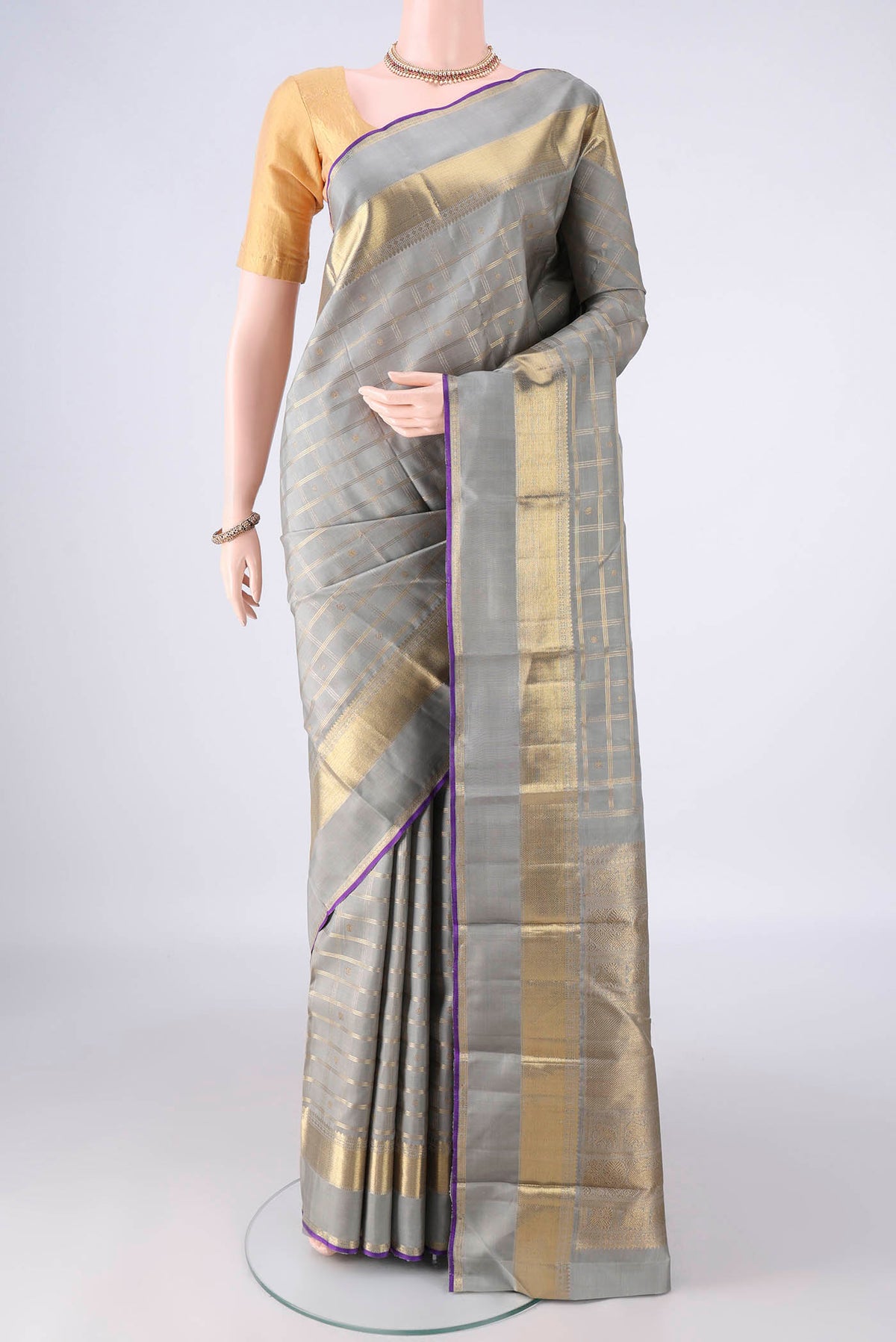 Pure Silk Pure Zari Grey Kanjivaram Saree with Checked design on the body and Zari Border.  displayed on a mannequin