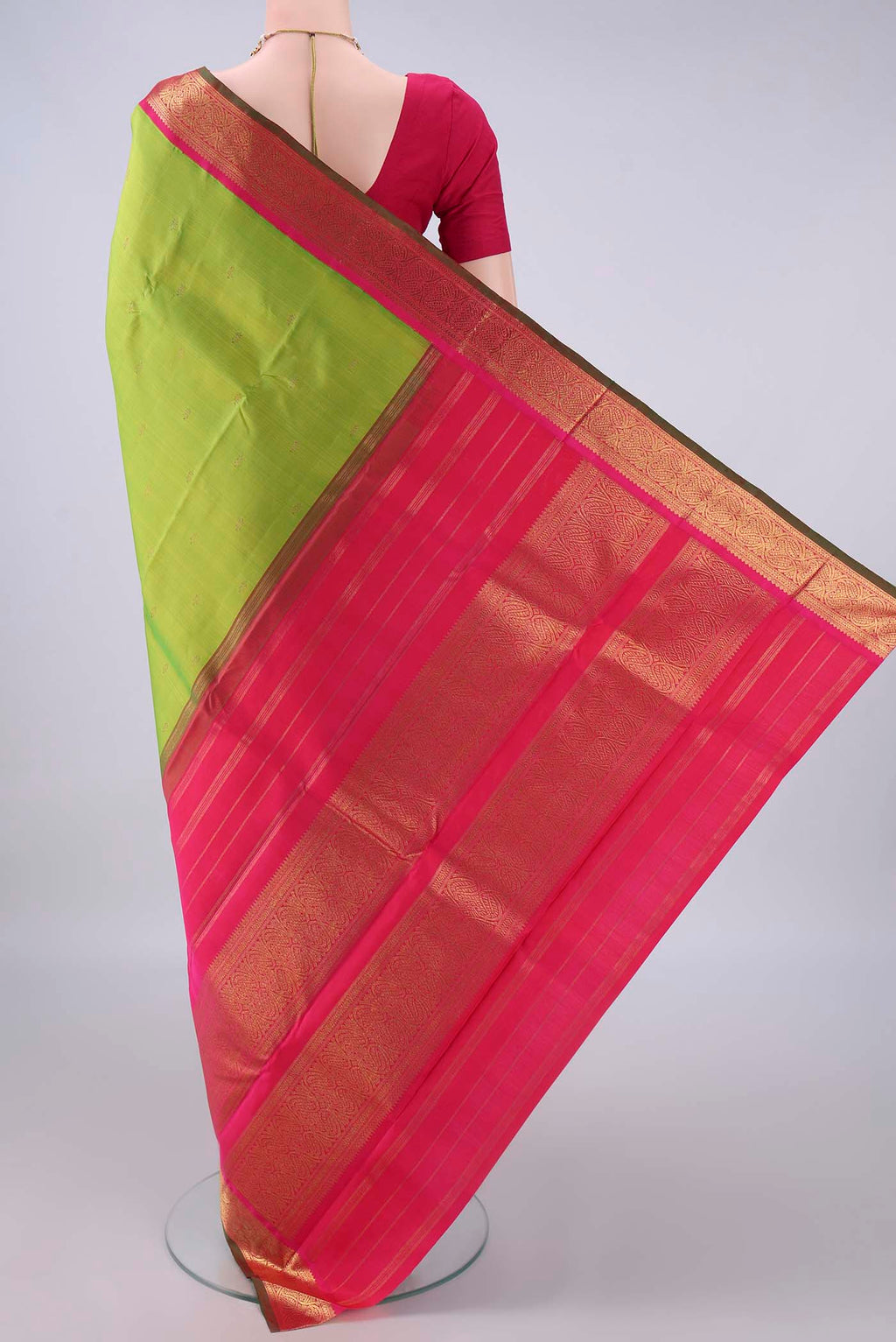 Flat view of Pure Silk Pure Zari Parrot Green Kanjivaram Saree with Zari Butta on the body and Zari Border. 