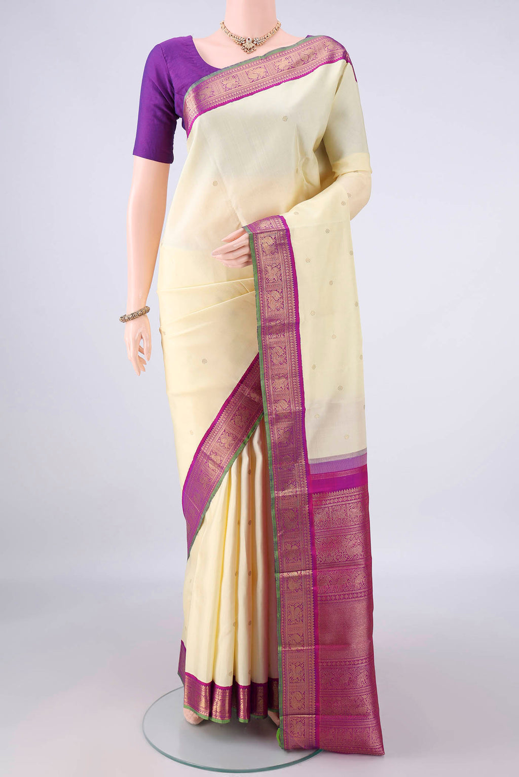 Pure Silk Pure Zari Cream Kanjivaram Saree with Zari Butta on the body and Zari Border.  displayed on a mannequin