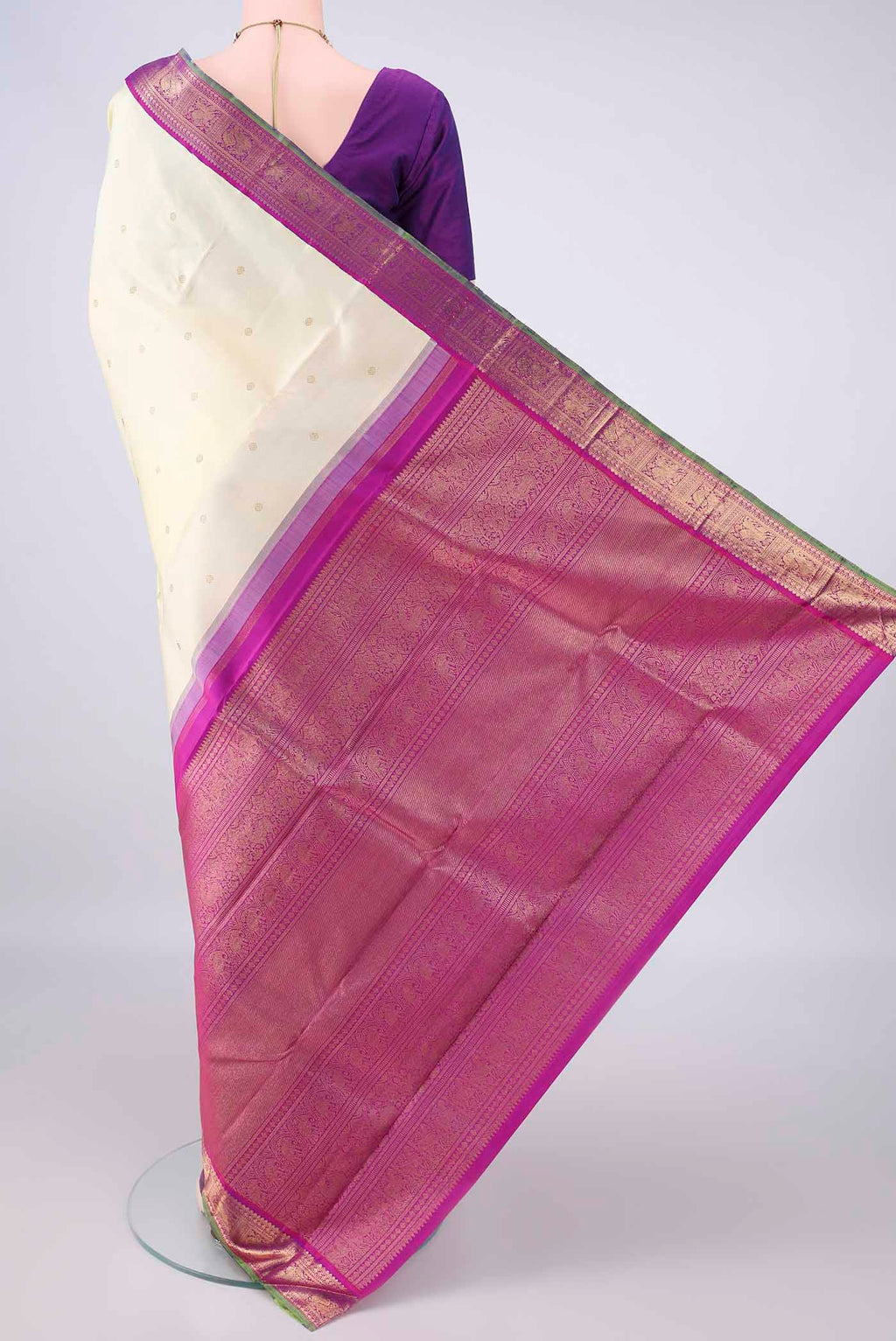 Flat view of Pure Silk Pure Zari Cream Kanjivaram Saree with Zari Butta on the body and Zari Border. 