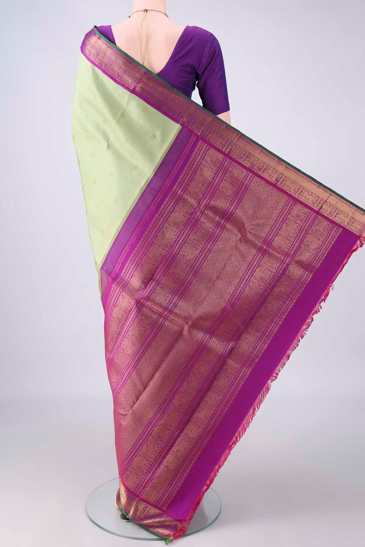 Flat view of Pure Silk Pure Zari Pista Green Kanjivaram Saree with Zari Butta on the body and Zari Border. 