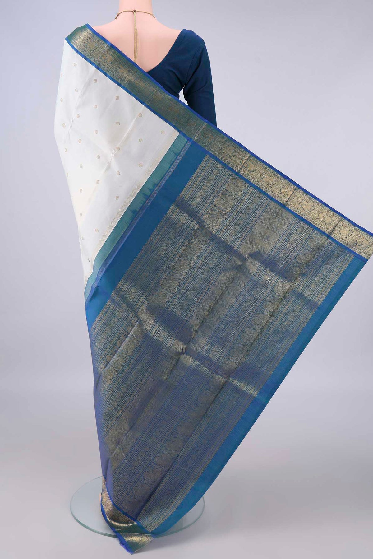 Flat view of Pure Silk Off White Kanjivaram Saree with Zari Butta on the body and Zari Border. 