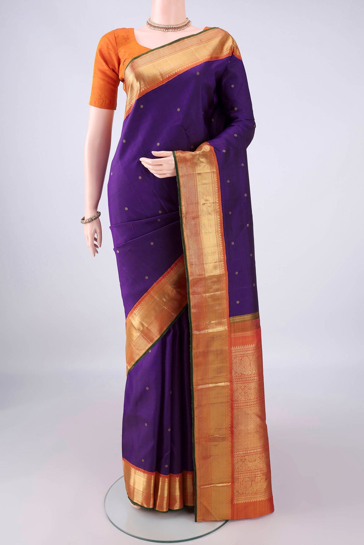 Pure Silk Pure Zari Purple Kanjivaram Saree with Zari Butta on the body and Zari Border.  displayed on a mannequin