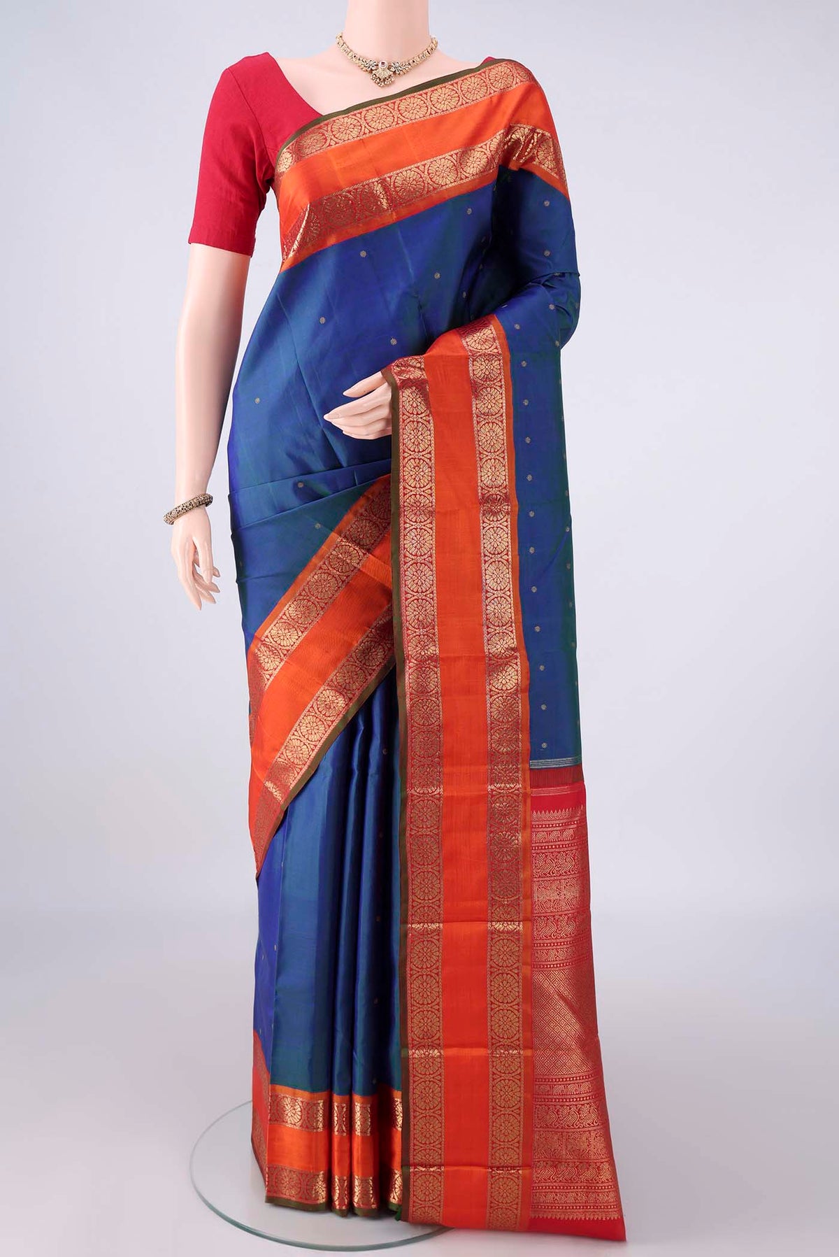 Pure Silk Pure Zari Peacock Blue Kanjivaram Saree with Zari Butta on the body and Zari Border.  displayed on a mannequin
