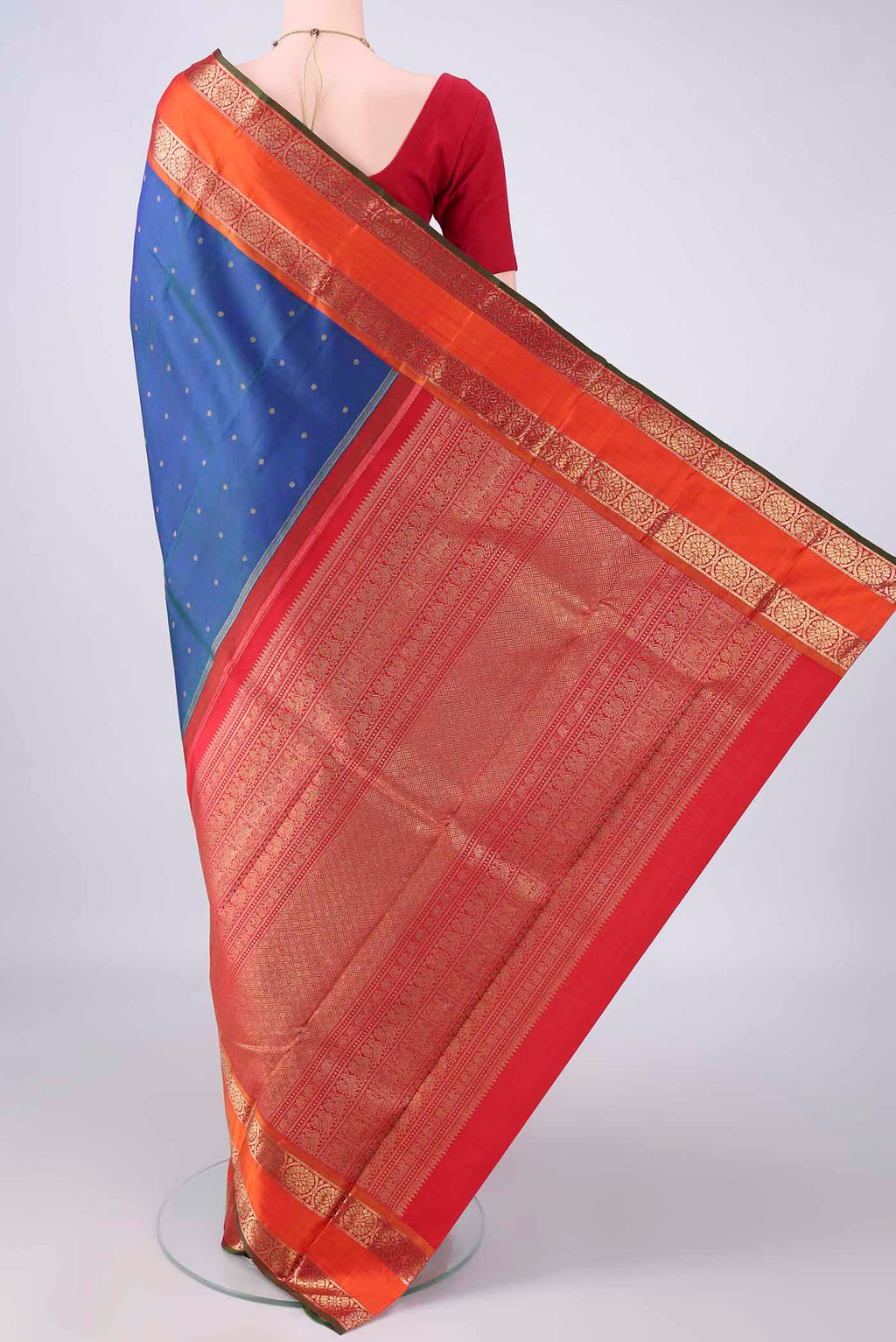 Flat view of Pure Silk Pure Zari Peacock Blue Kanjivaram Saree with Zari Butta on the body and Zari Border. 