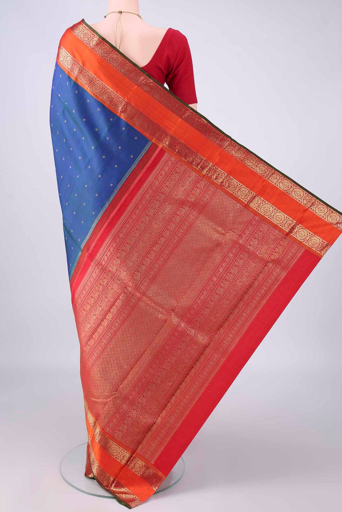 Flat view of Pure Silk Pure Zari Peacock Blue Kanjivaram Saree with Zari Butta on the body and Zari Border. 
