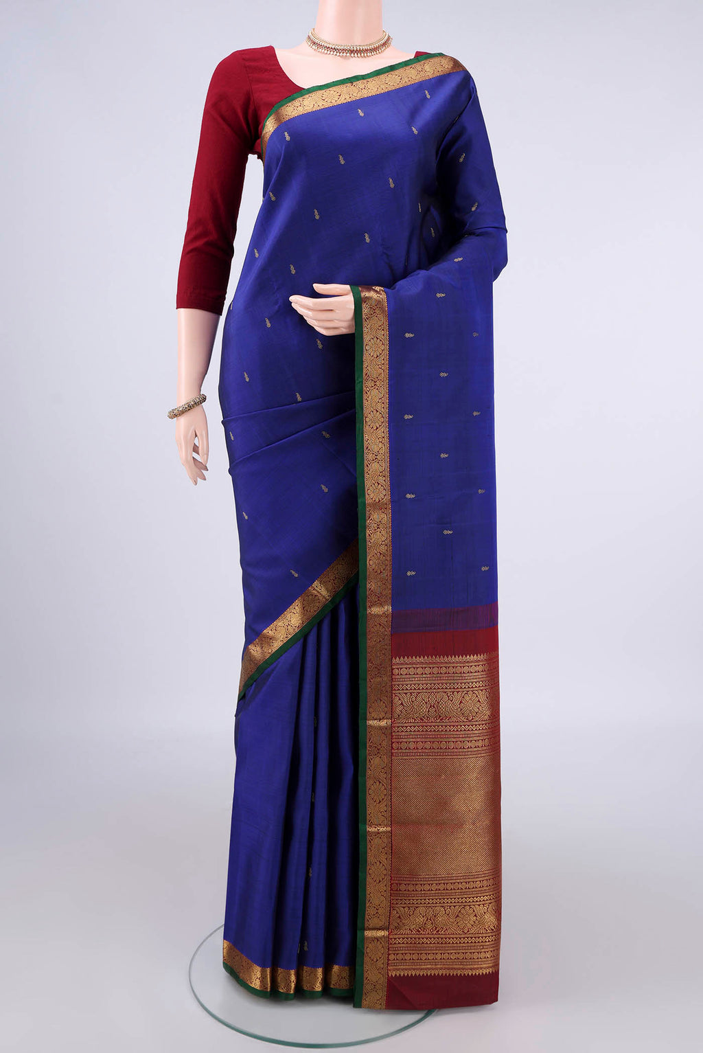 Pure Silk Pure Zari Dark Blue Kanchipuram Saree with Zari Butta on the body and Zari Border.  displayed on a mannequin