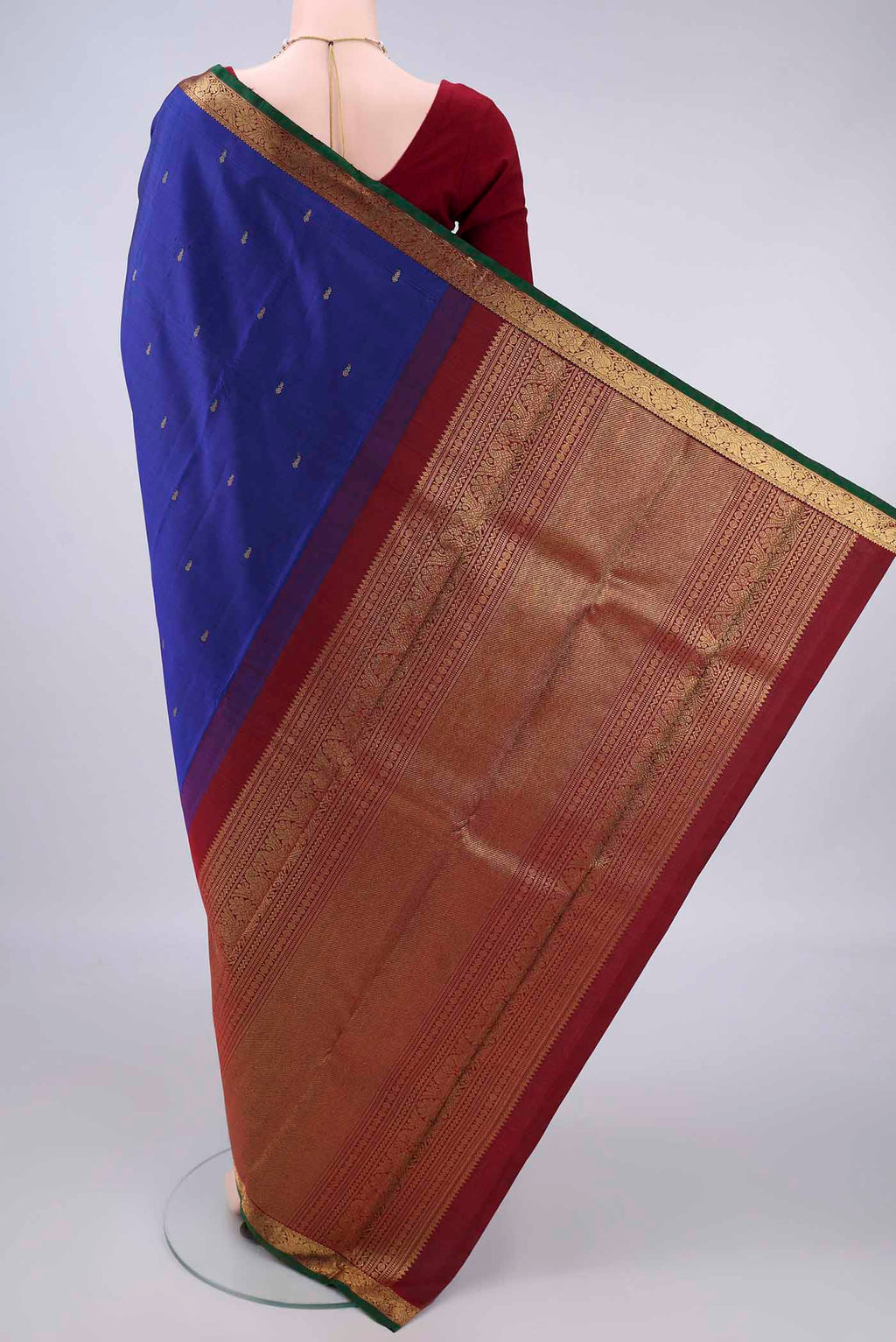 Flat view of Pure Silk Pure Zari Dark Blue Kanchipuram Saree with Zari Butta on the body and Zari Border. 