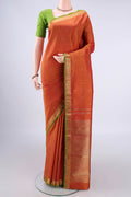 Pure Silk Pure Zari Brick Orange Kanchipuram Saree with Zari Butta on the body and Zari Border.  displayed on a mannequin