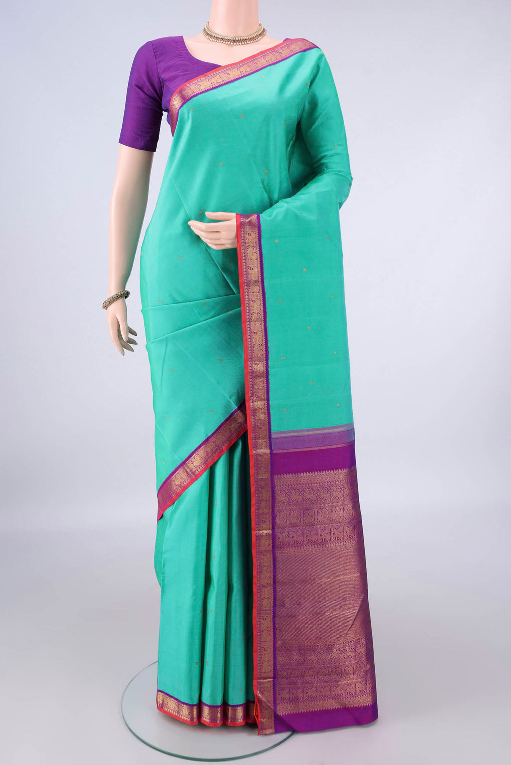 Pure Silk Pure Zari Sea Green Kanjivaram Saree with Zari Butta on the body and Zari Border.  displayed on a mannequin