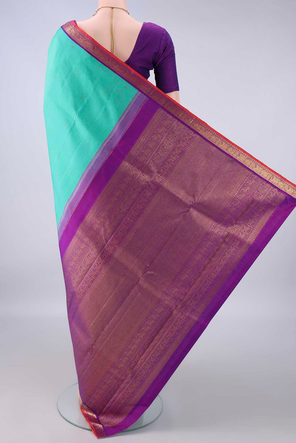 Flat view of Pure Silk Pure Zari Sea Green Kanjivaram Saree with Zari Butta on the body and Zari Border. 