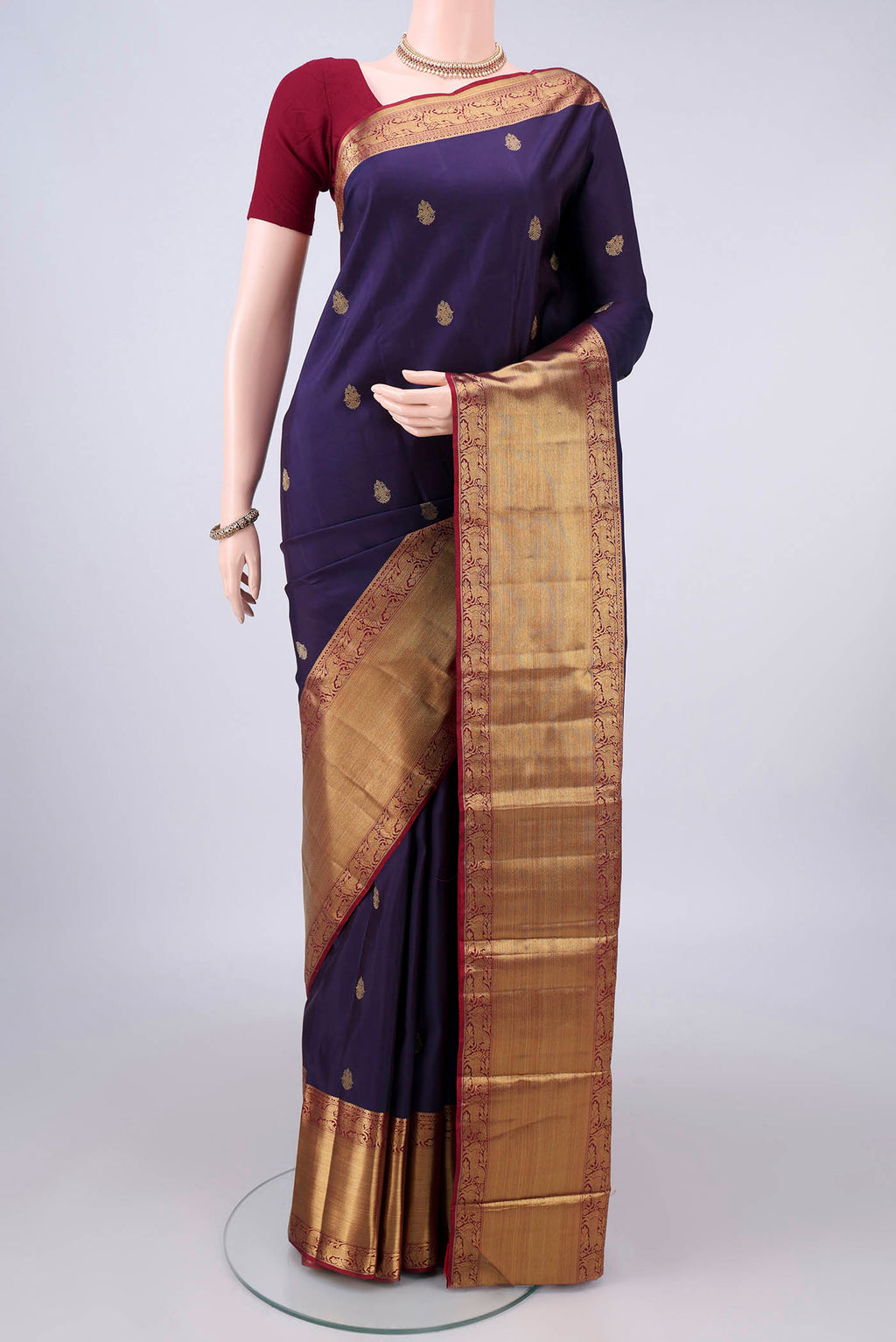 Pure Silk Pure Zari Navy Blue Kanjivaram Saree with Zari Butta on the body and Zari Border.  displayed on a mannequin