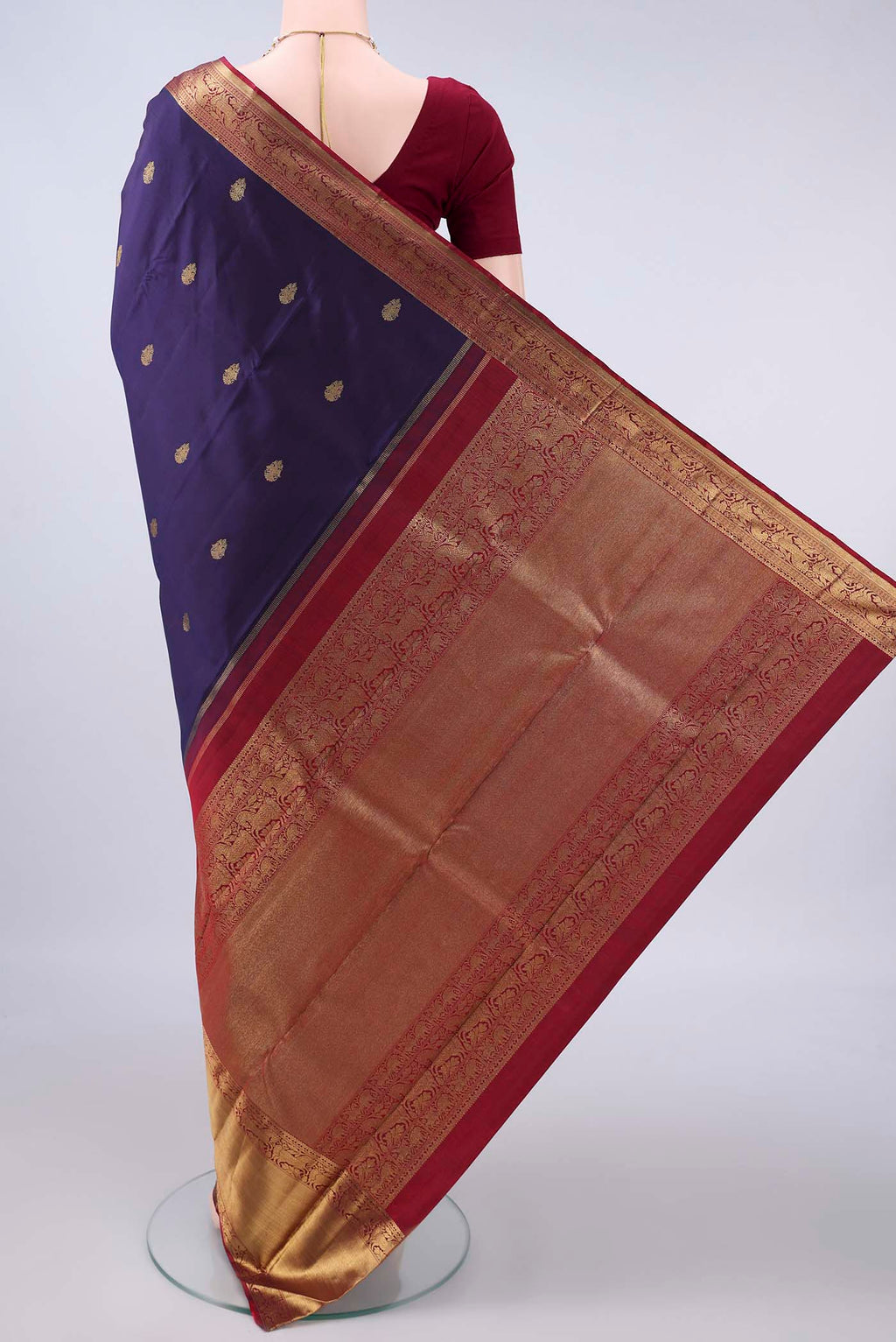 Flat view of Pure Silk Pure Zari Navy Blue Kanjivaram Saree with Zari Butta on the body and Zari Border. 