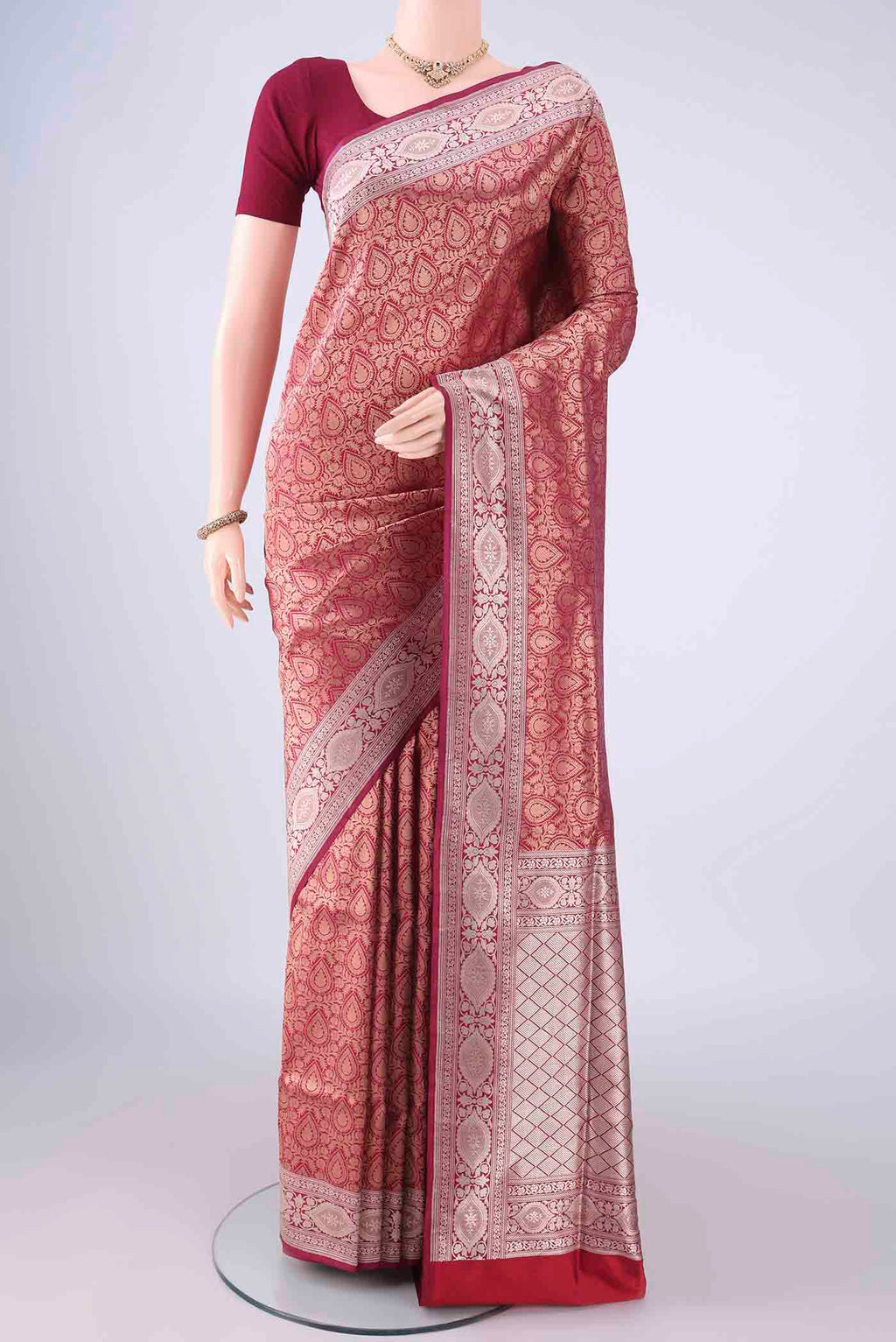 Maroon Banarasi Silk Saree with Zari Brocade on the body and Zari Border.  displayed on a mannequin